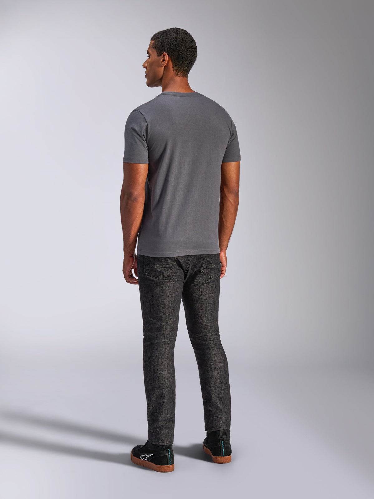 Alpinestars Always 2.0 CSF Tee, Short Sleeve T-Shirt, Charcoal Gray, Back view on model, paired with dark denim pants and black sneakers, casual motorsport-inspired streetwear