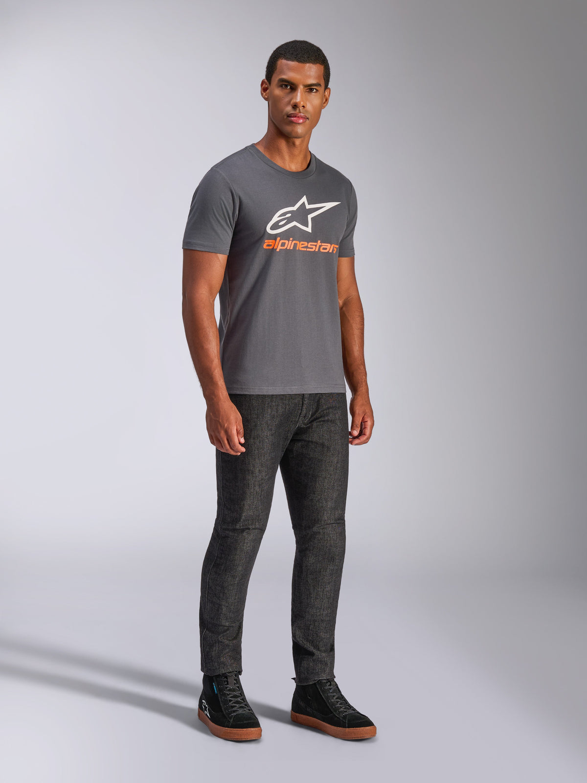 Alpinestars Always 2.0 CSF Tee, Short Sleeve T-Shirt, Charcoal Grey, White A-star Logo with Orange Branding, casual motorsport streetwear worn with dark jeans and black sneakers