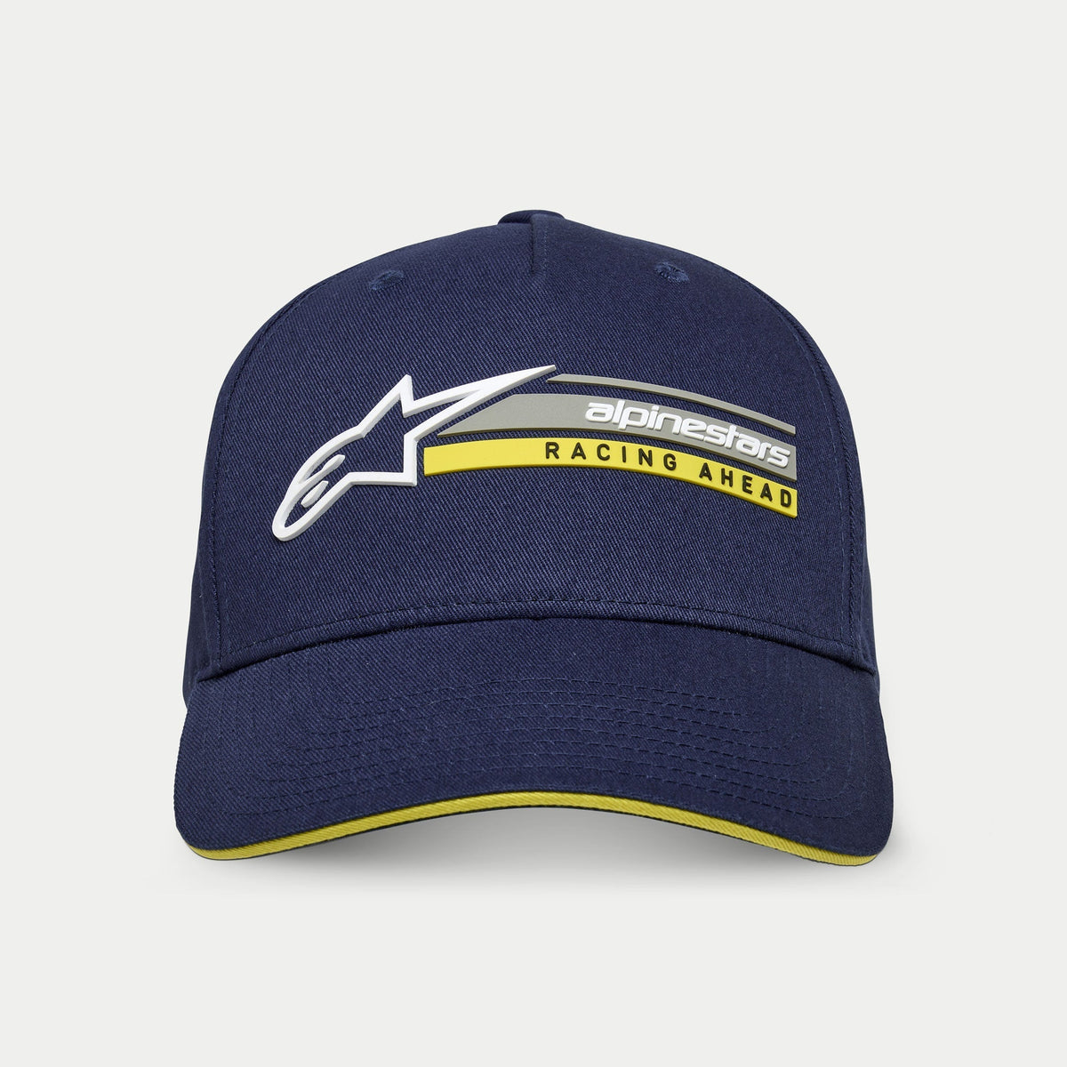 Alpinestars Par Mütze, Marineblau, strukturierte Snapback-Kappe mit gebogenem Schirm, weißes 3D-Astars-Logo und „alpinestars RACING AHEAD“-Grafik in Grau und Gelb, gelber Sandwich-Schirm-Akzent, lässige Motorsport-Streetwear