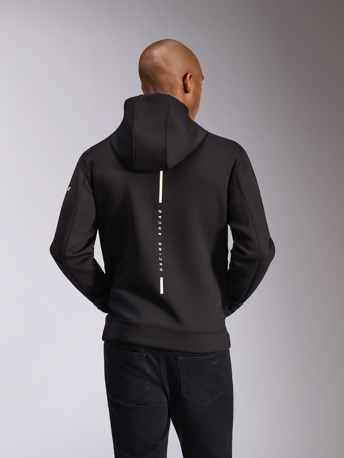 Alpinestars Insight Hoodie, achteraanzicht, zwart, verticale witte streep met de tekst 'RACING AHEAD', woordmerk op de mouw, casual motorsport-geïnspireerde streetwear