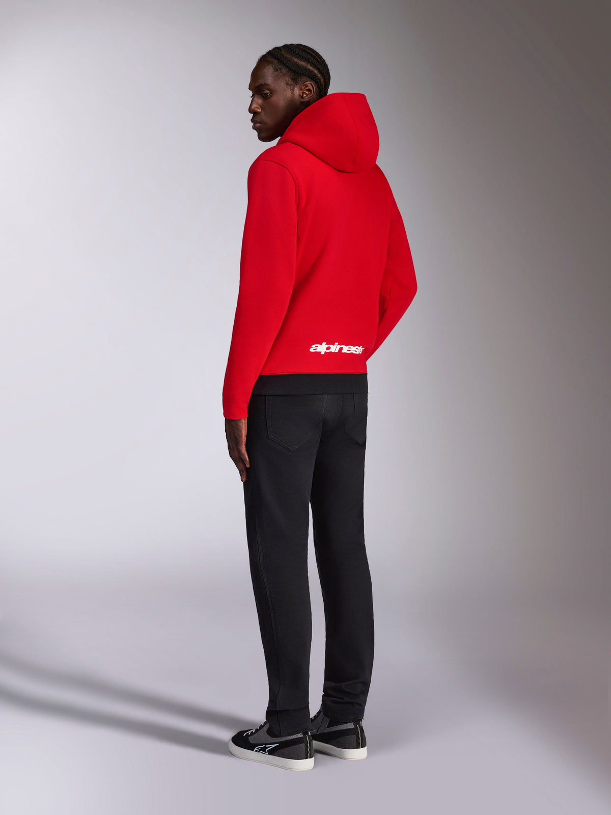 Alpinestars Parallel Hoodie, achteraanzicht van rode fleece pullover met zwarte geribde zoom, voorzien van wit Alpinestars-logo op de onderrug, casual motorsport streetwear-stijl