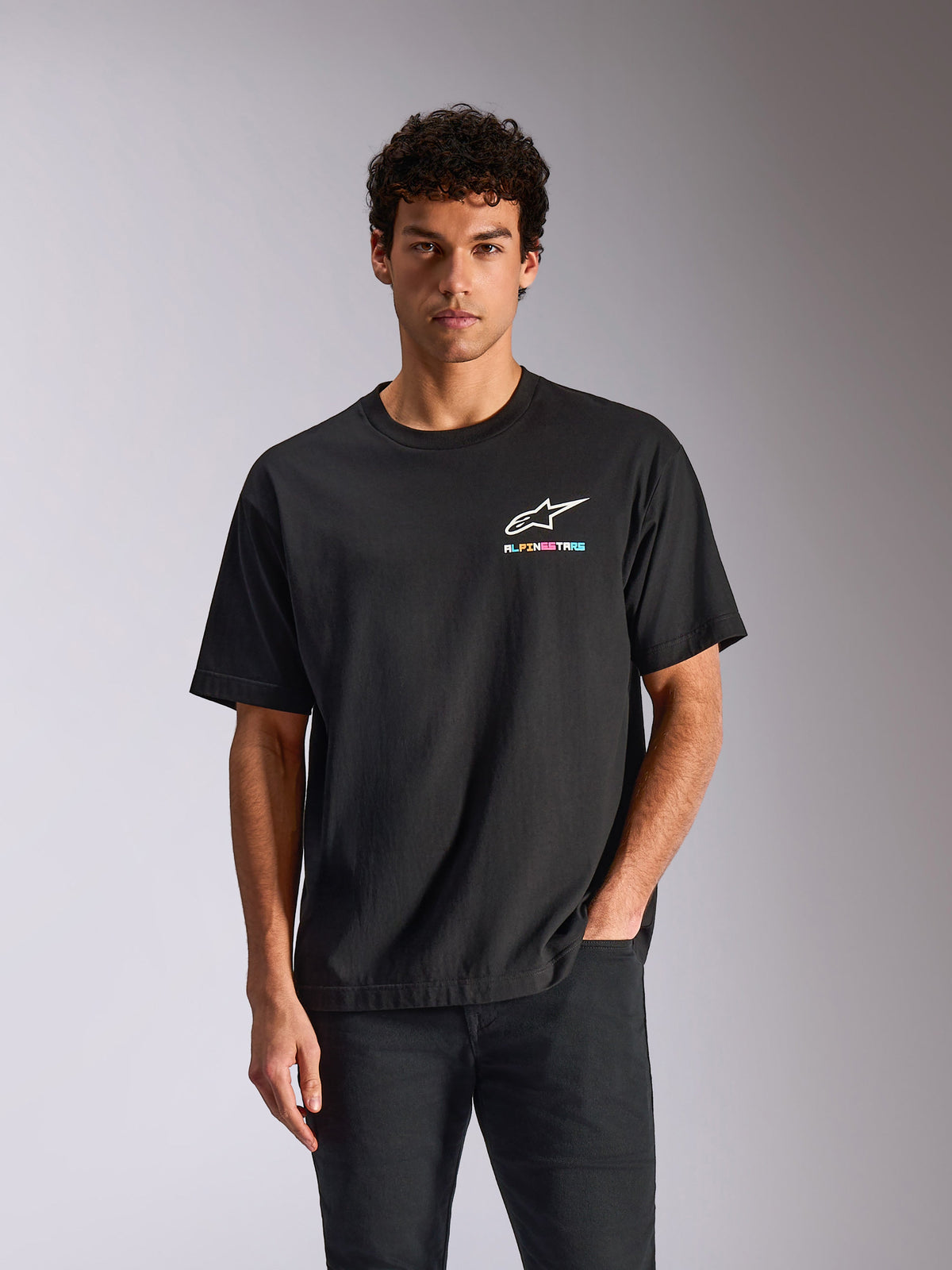 T-shirt Alpinestars Wild Oversized CSF, t-shirt à manches courtes, noir, logo Astars blanc avec texte multicolore vibrant, streetwear décontracté inspiré par les sports mécaniques
