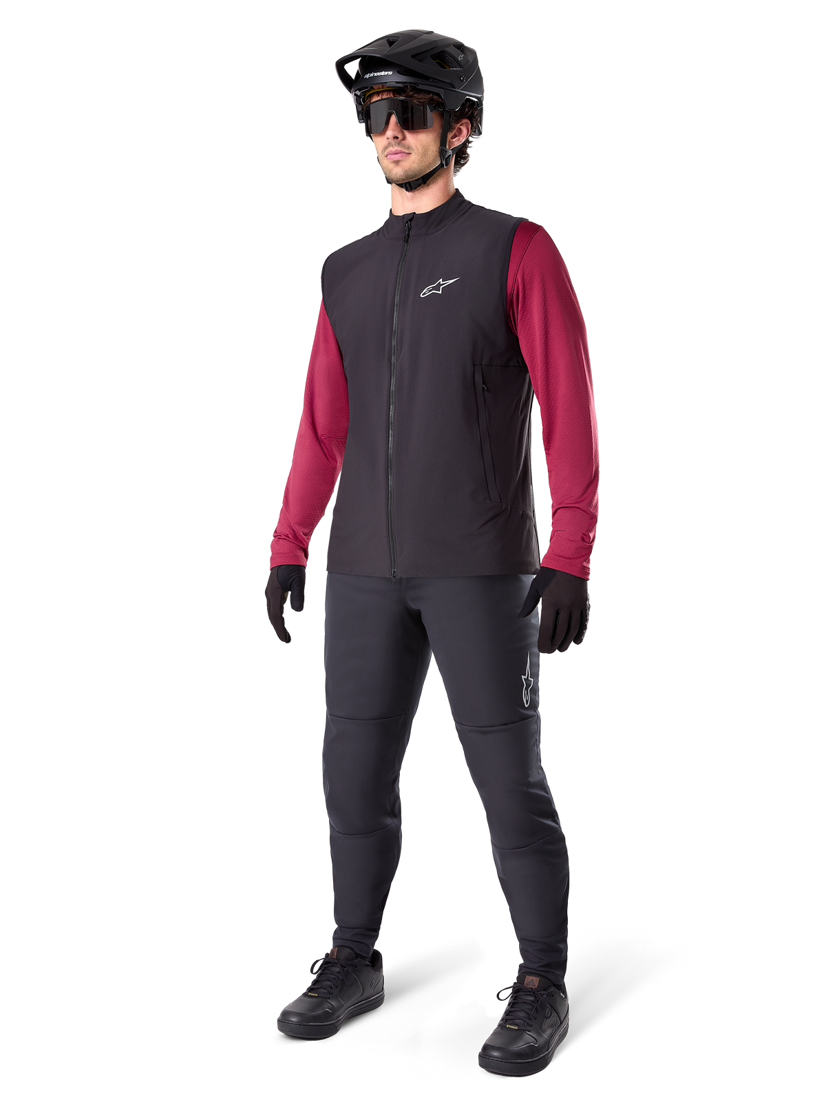 Alpinestars A-Dura Thermal Vest, Black cycling vest, worn by a rider over a maroon long-sleeve jersey and black pants, featuring a black MTB helmet and gloves, designed for cold-weather mountain biking
