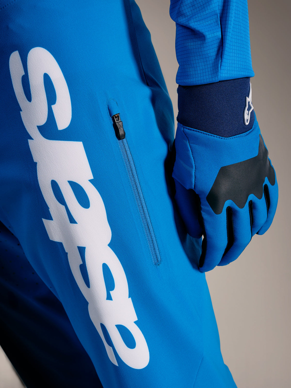 A-Supra Elite MTB-Hose in Hellblau mit großem weißen Astars-Schriftzug und vertikaler Reißverschlusstasche.
