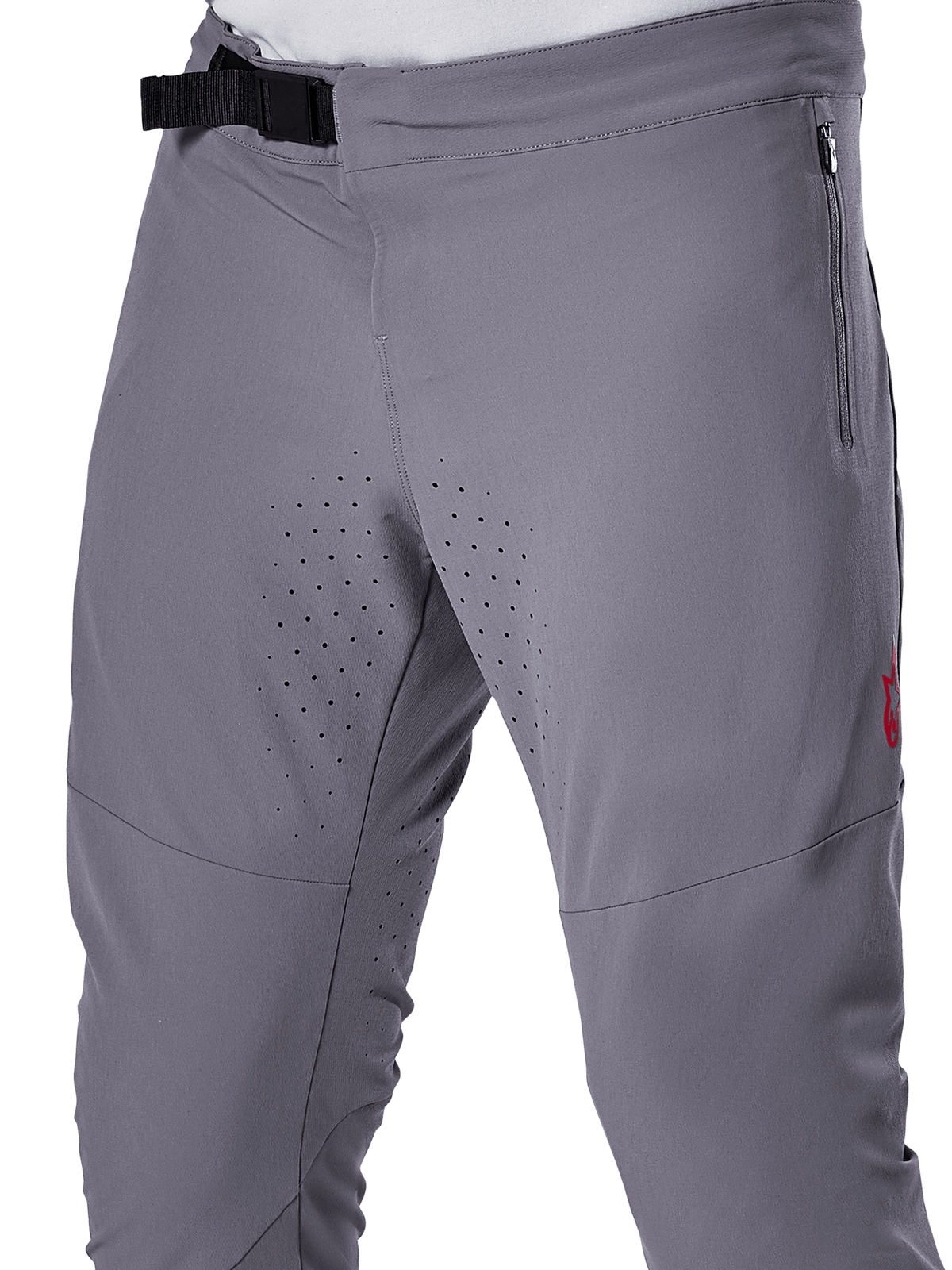 Pantalon Alpinestars A-Aria Elite, pantalon de VTT, gris foncé, vue rapprochée présentant la fermeture à boucle magnétique, la poche latérale zippée et les perforations de ventilation laser sur l'intérieur des cuisses pour la performance en trail.