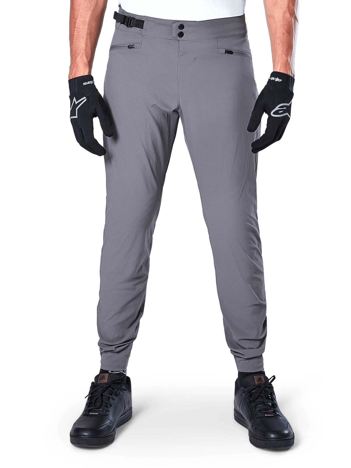 Alpinestars A-Dura Pants, Dark Gray Mountain Bike Pants, front view worn with black gloves and black sneakers, featuring double snap waist closure, zippered hand pockets, and elasticated cuffs, durable cycling apparel for trail riding