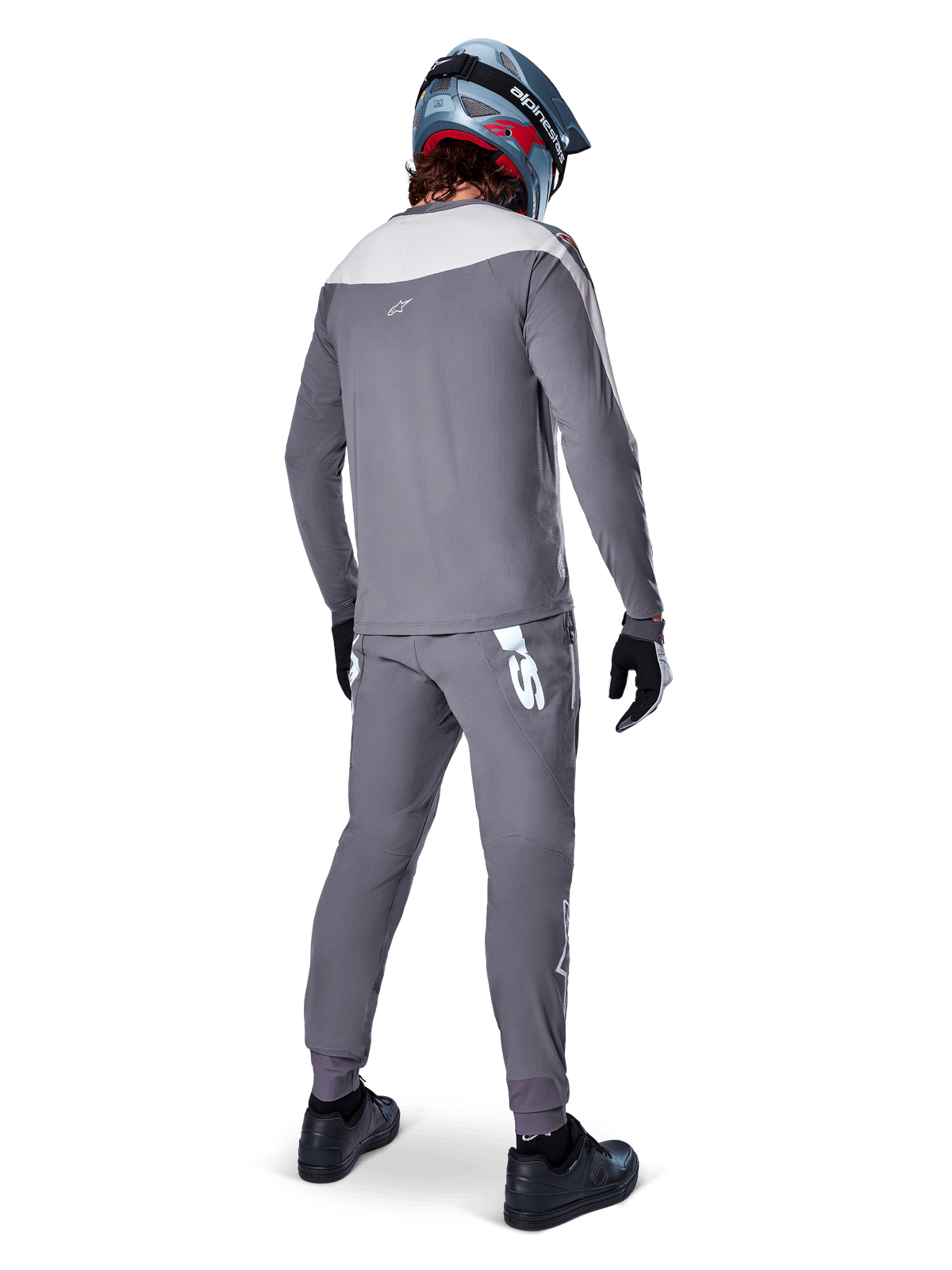 Alpinestars A-Supra Race Pants, Dark Gray, Mountain bike rider from behind wearing full racing kit, gray long-sleeved jersey, dark gray pants with white MX-inspired logo on back yoke, gray and blue helmet, black shoes, designed for MTB performance