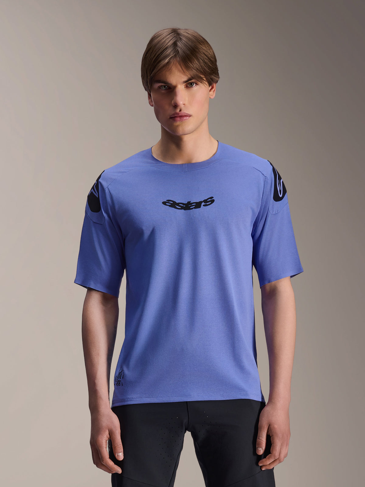 Alpinestars A-Aria Polartec Elite Jersey, mountainbike shirt met korte mouwen, Baja Blue, gedragen door een mannelijk model, met zwart 'astars' woordmerk op de borst en logo's op de schouders, technische trail-kleding
