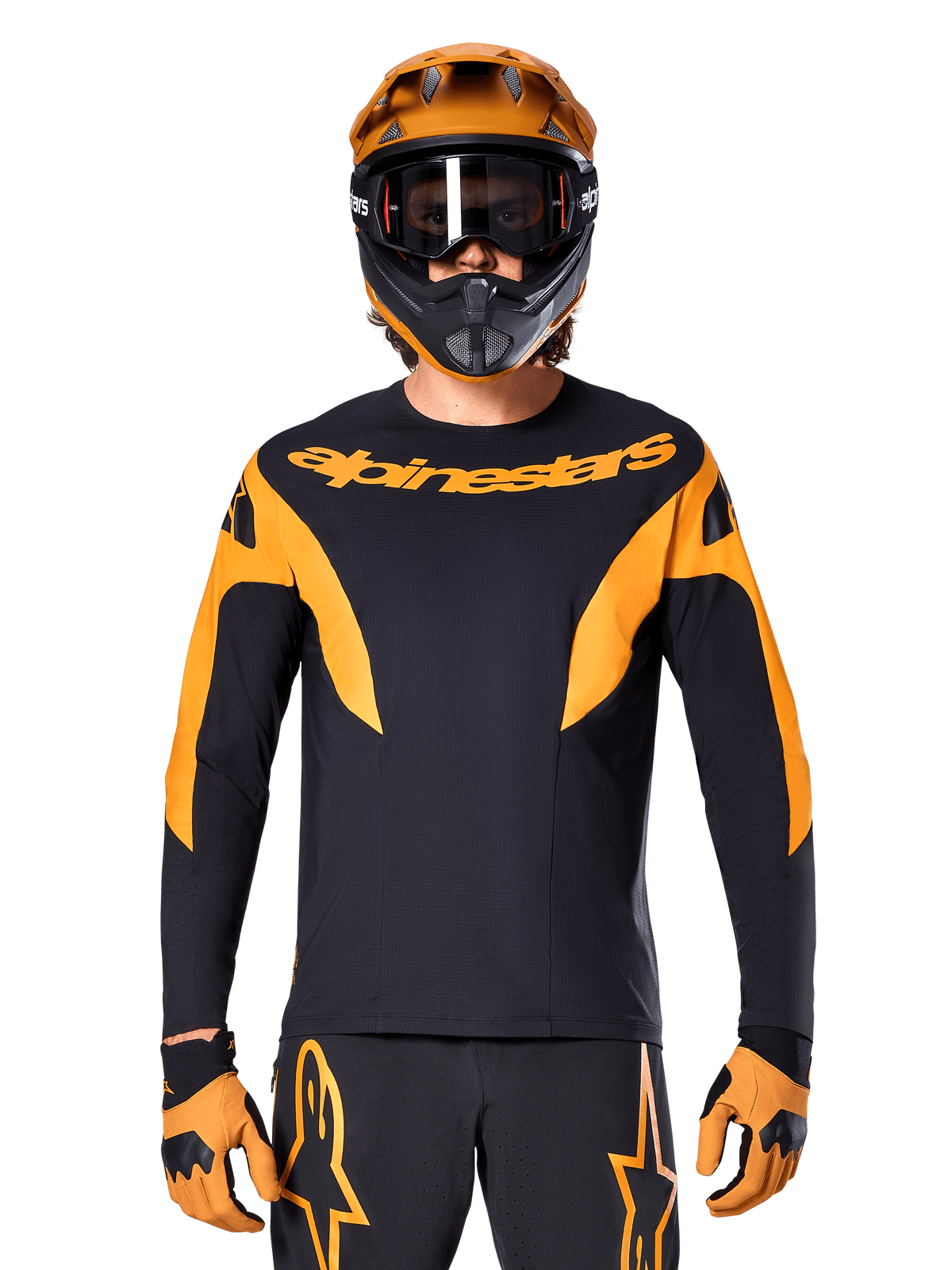MTB rider wearing Alpinestars A-Supra Race Jersey - Long Sleeve, Black with orange graphics and chest logo, worn with matching orange full-face helmet, black goggles, and orange gloves, coordinated racing kit for mountain bike performance