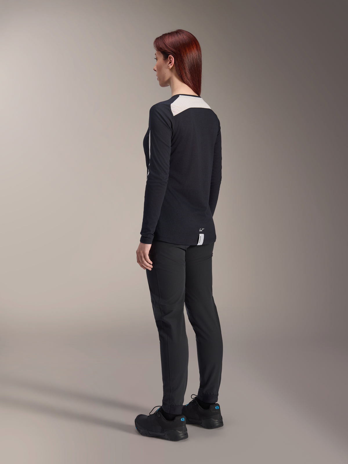 Alpinestars Damen Stella A-Dura Hose und Stella A-Dura Elite Trikot, Schwarz, Rückansicht mit weißen Mesh-Schultereinsätzen am langärmeligen Trikot, schmal geschnittene technische Hose, koordinierte Performance-Mountainbike-Ausrüstung.