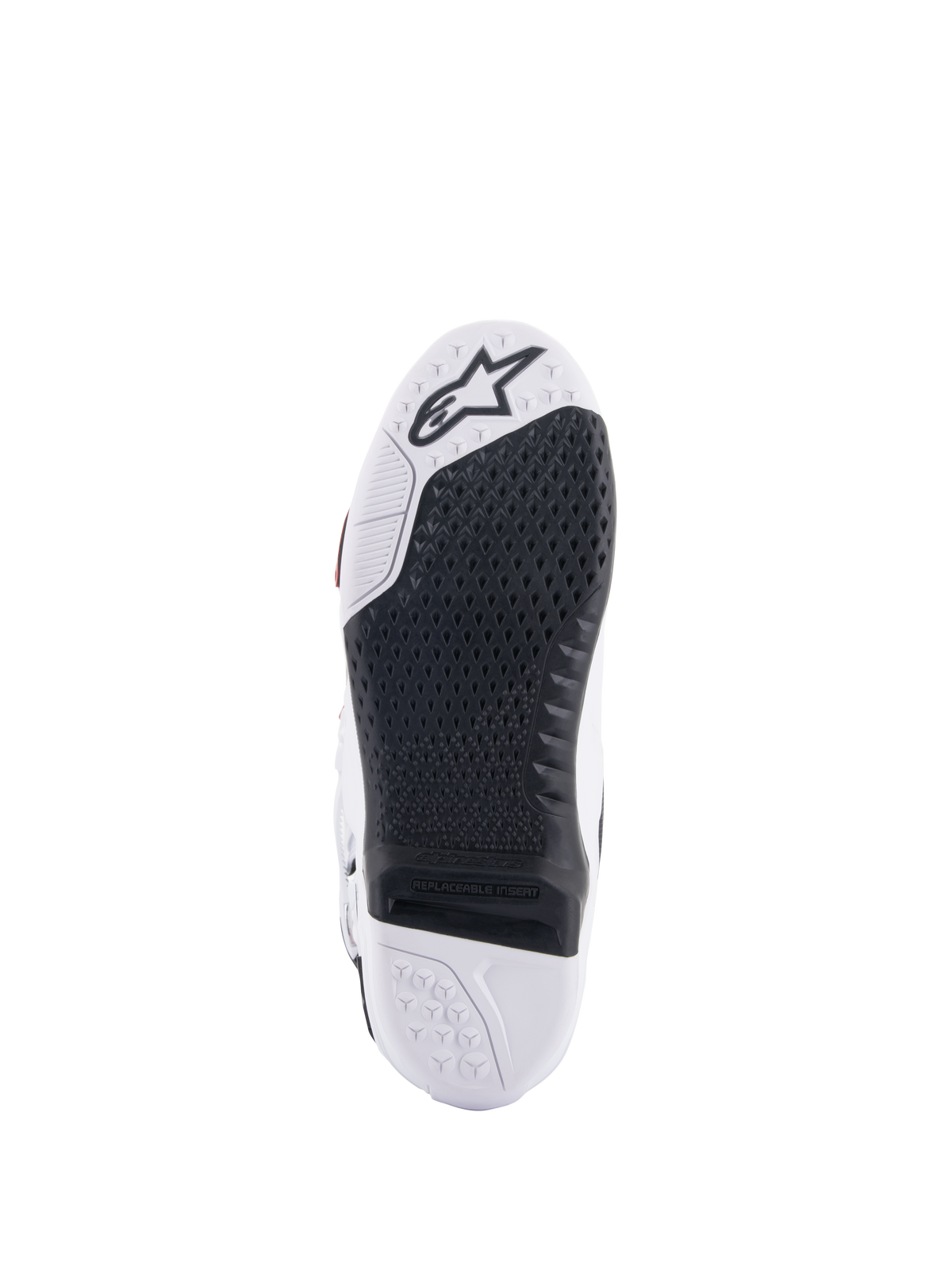 Alpinestars Tech 10 Supervented laarzen, wit en zwart zoolaanzicht, voorzien van een uitgebreid honingraat gripontwerp, zwarte vervangbare centrale insert, witte neus met Alpinestars sterlogo, geoptimaliseerd voor controle op de motorcross voetsteun.
