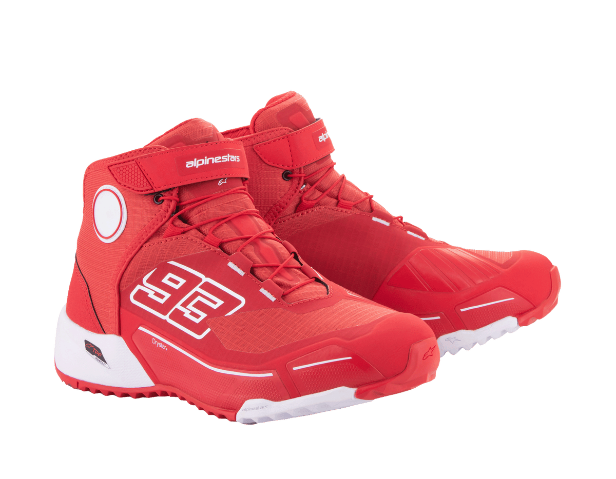 Chaussures de moto Alpinestars MM93 CR-X Drystar®, rouge vif et blanc, vue latérale, arborant le graphisme '93' sur le côté, logo Alpinestars sur la sangle, semelle technique blanche et silhouette inspirée des chaussures de course pour la moto