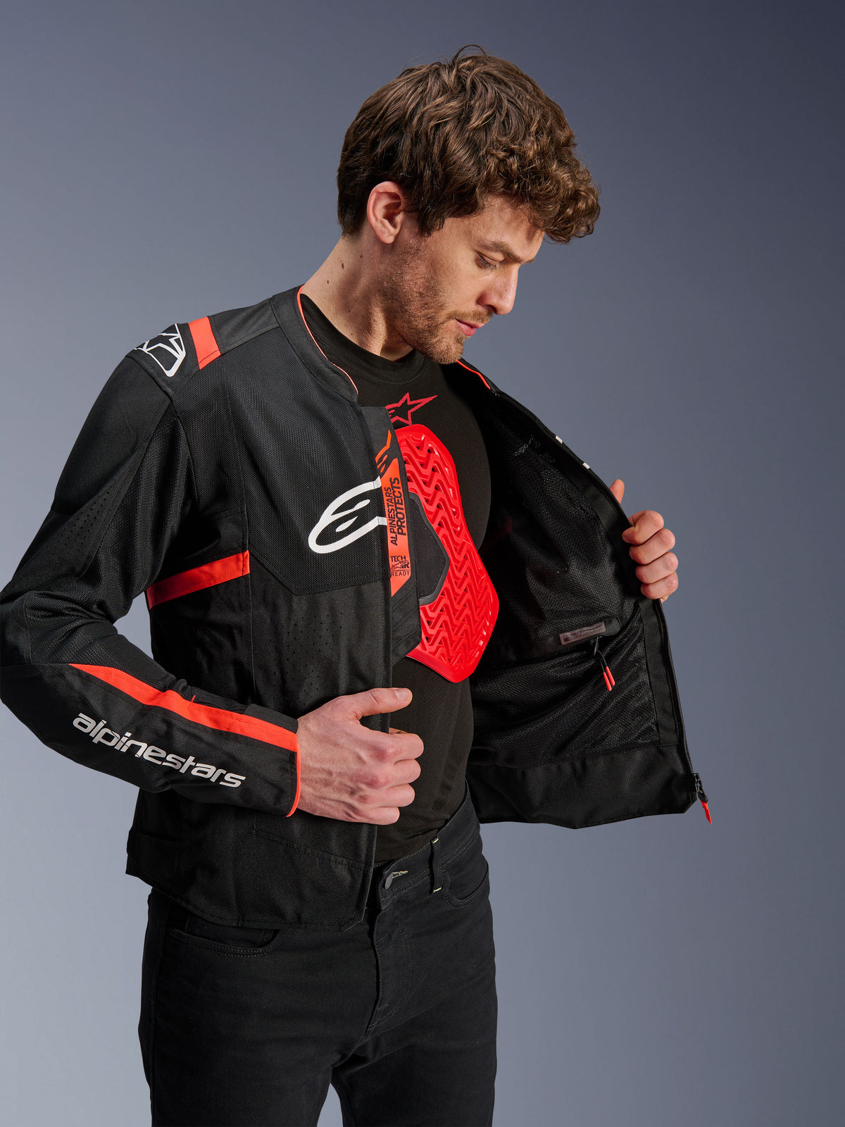 Alpinestars T-SPS Air V2 Jacket in black and red, featuring internal mesh lining and a red Nucleon chest protector.