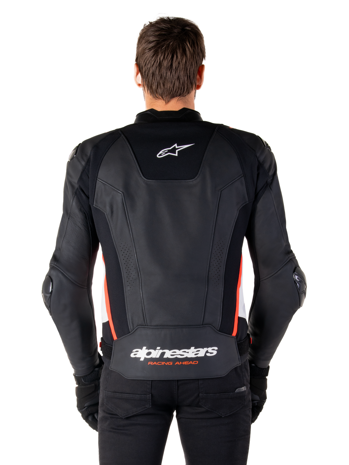 Alpinestars Missile V3 Leather Jacket, back view, premium black leather with red fluo and white accents, featuring a white star logo on the upper back and Alpinestars branding on the lower back, worn with black pants and gloves.