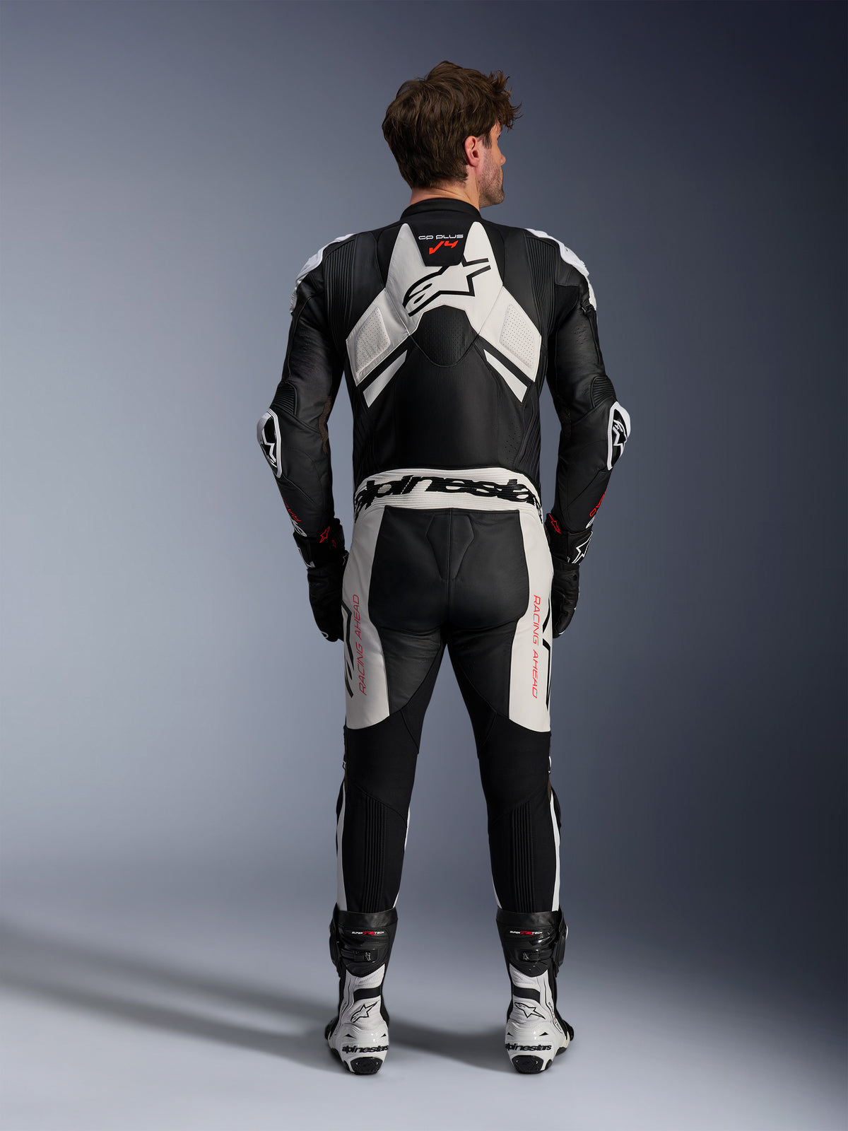 Alpinestars GP Plus V4 Sprint Lederkombi, Herren-Rennkombi, Schwarz, Weiß, Rot Fluo, Rückansicht mit aerodynamischem Höcker.