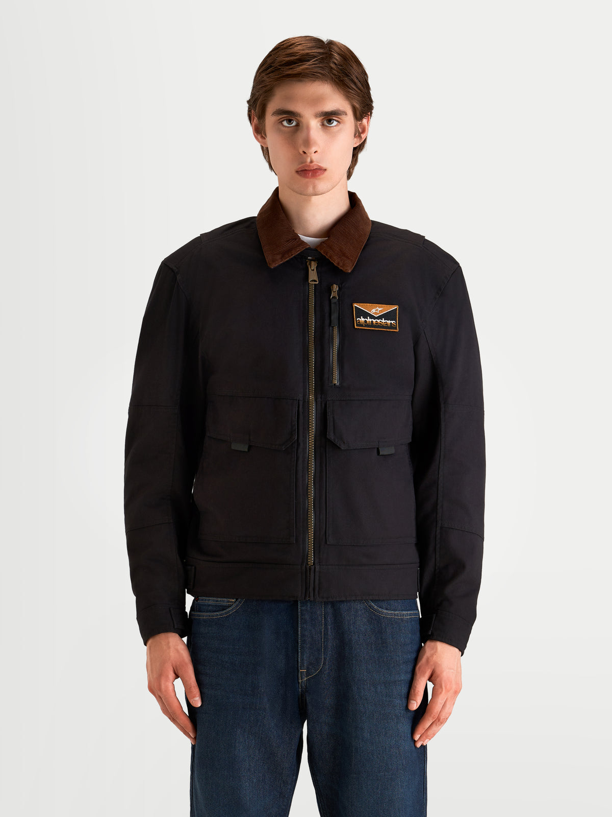 Alpinestars Mustang Waterproof Jacket, men's urban contemporary motorcycle jacket in dark anthracite and dark brown, front view on a model showing workwear-styled stretch twill construction and corduroy collar.