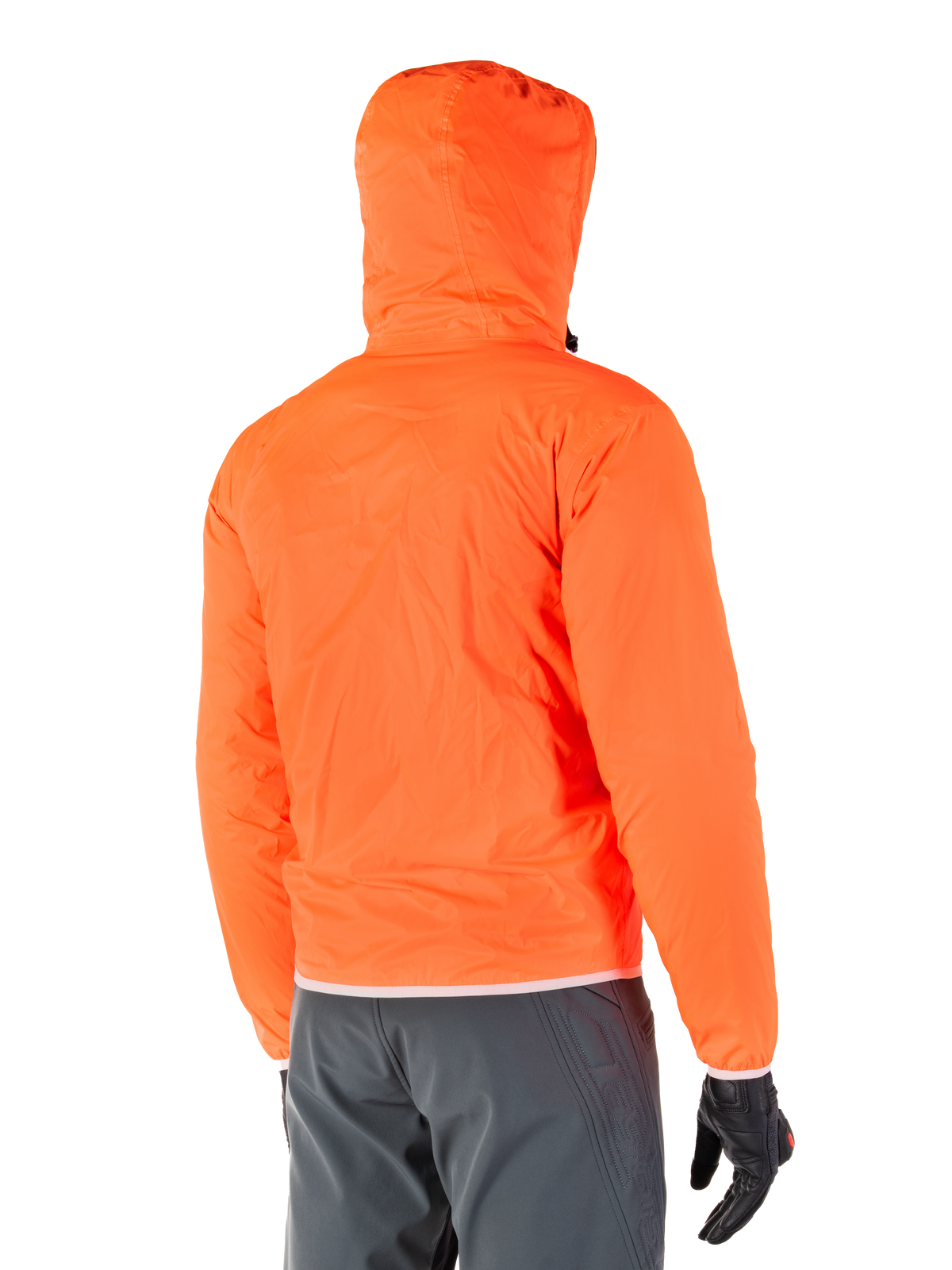 Alpinestars Mohobbs Waterproof Jacke, packbarer Notfall-Regenschutz in leuchtendem Orange Fluo, Rückansicht mit sturmsicherer Kapuze, kombiniert mit dunkelgrauer Fahrhose und schwarzen Handschuhen, leichte wasserdichte urbane Motorradausrüstung