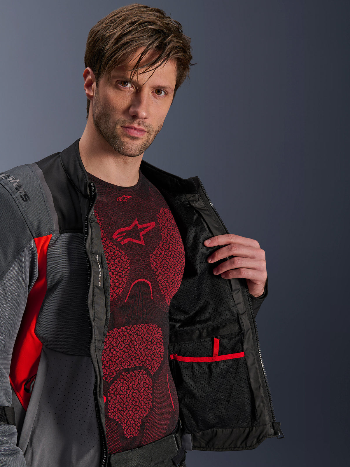 Alpinestars ST-2 Air jas, adventure-motorjas voor heren, grijs en rood, opengeritst met mesh-voering en binnenzak.