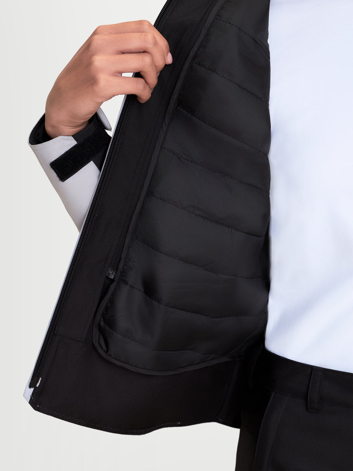 Alpinestars Stella C-1 Waterproof Jacket, women's urban motorcycle jacket in ice gray and black, close-up view showing the interior quilted thermal vest and front zipper construction worn by a model