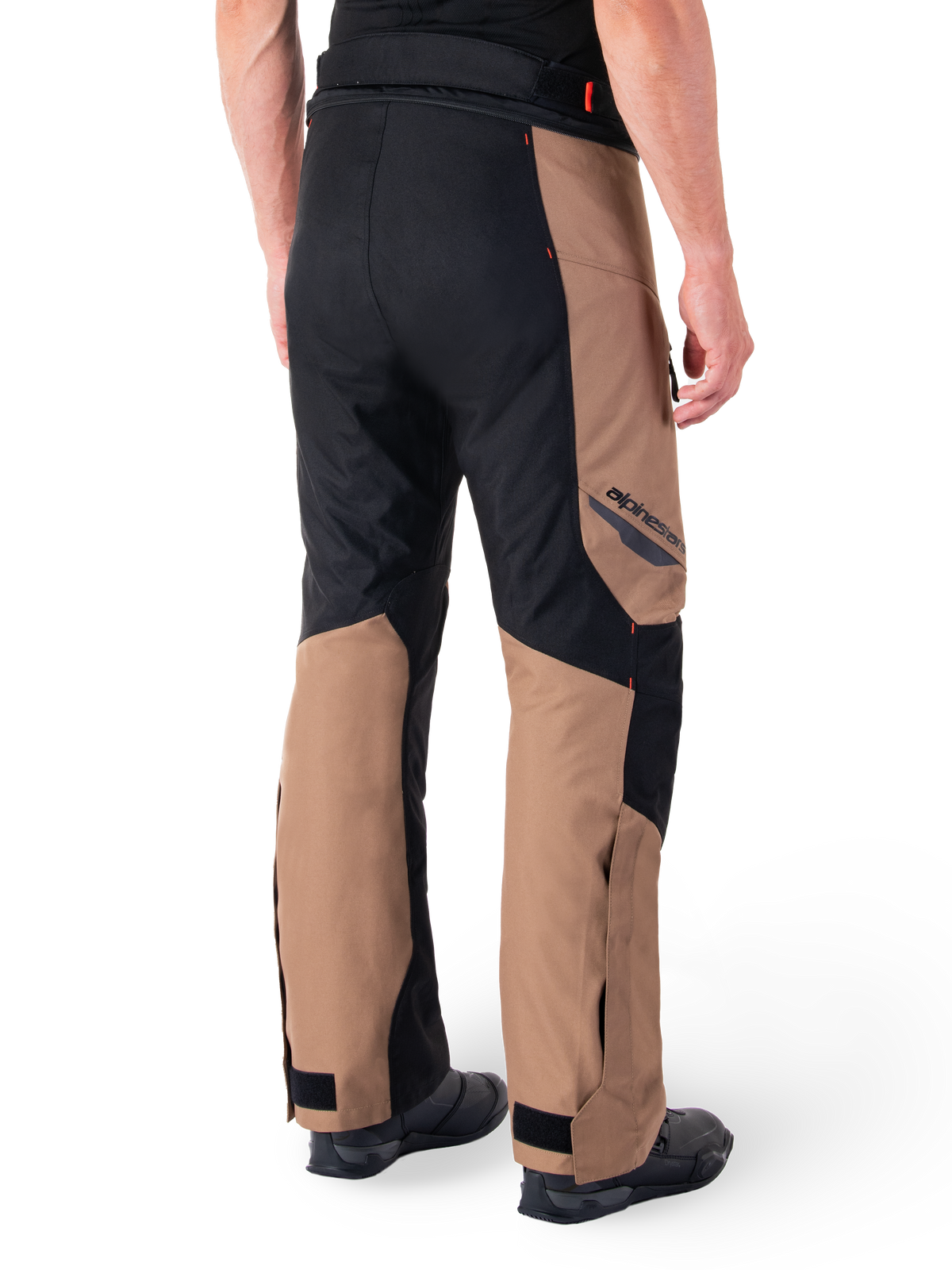 Alpinestars St-1 Waterproof Pants, Motorcycle Touring Pants, Dark Khaki Sand and Black with Red Fluo accents, rear three-quarter view, featuring Alpinestars branding on the thigh and adjustable ankle straps, worn with black boots.