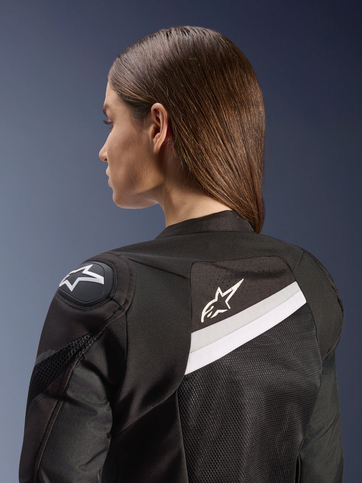 Alpinestars Stella T-GP Plus R V4 Airflow Jacket, Women's Sport Motorcycle Jacket, Black and White, featuring mesh back panels and white accents, Alpinestars logo on the shoulder and back, anatomical fit for sport riding
