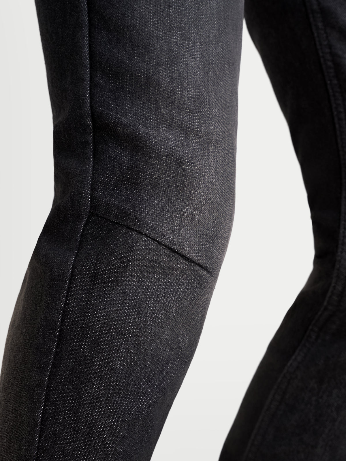 Alpinestars Stella Flex-AST 7 Denim Pants Short, women's urban motorcycle riding jeans, faded black, close-up view of the knee and leg construction showcasing single-layer technical denim and stretch mobility