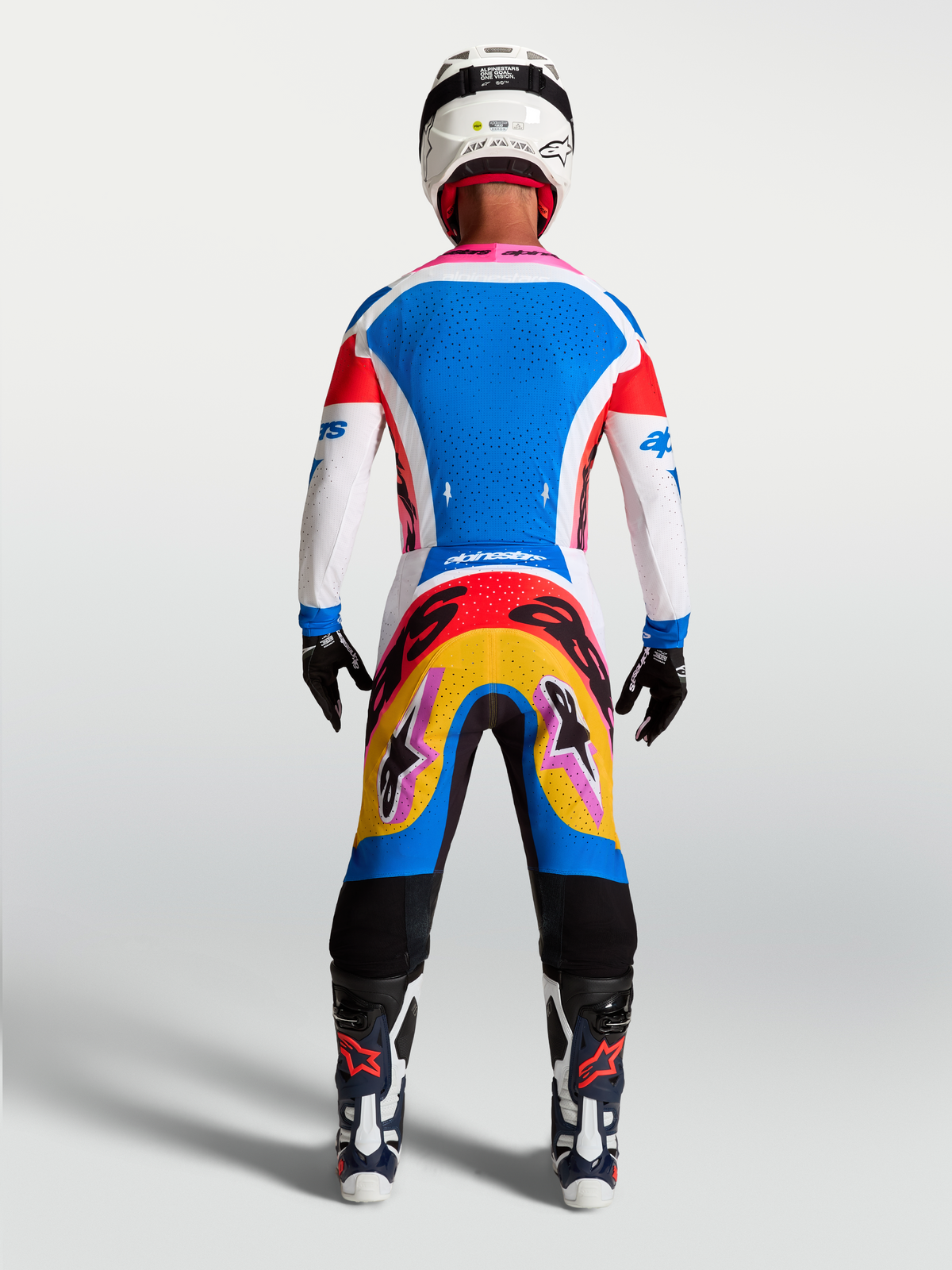 Alpinestars Supertech Dyna Motocross Gear Set, men's blue and white jersey and pants with vibrant graphics, rear on-model view.