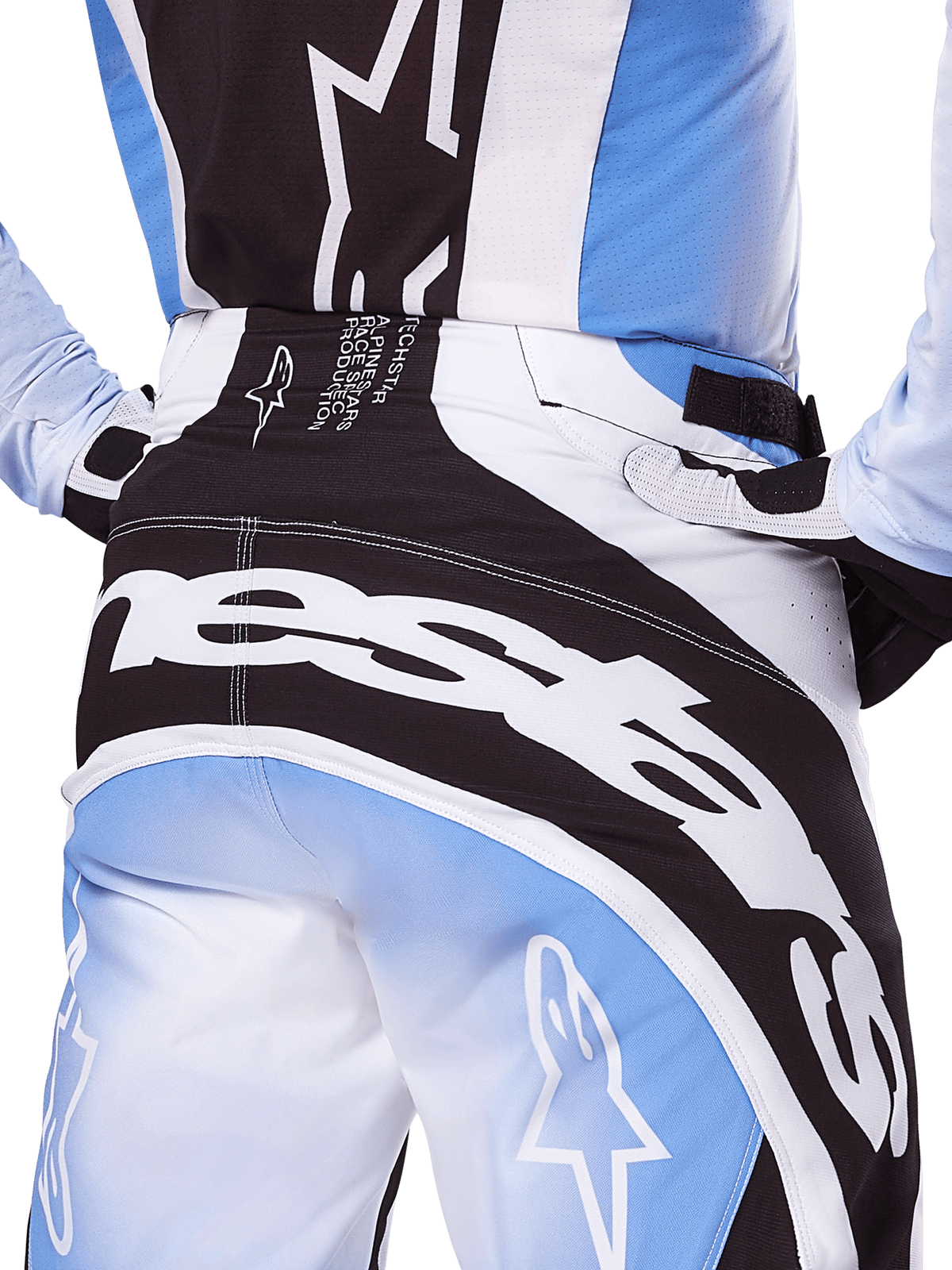 Alpinestars 2025 Techstar Melt Hose, Motocross-Hose, Schwarz, Weiß und Blau, Nahaufnahme der Rückansicht mit markantem weißem Branding auf dem Gesäß, kombiniert mit passendem Techstar Melt Trikot und Handschuhen, professionelle Rennausrüstung für Motocross