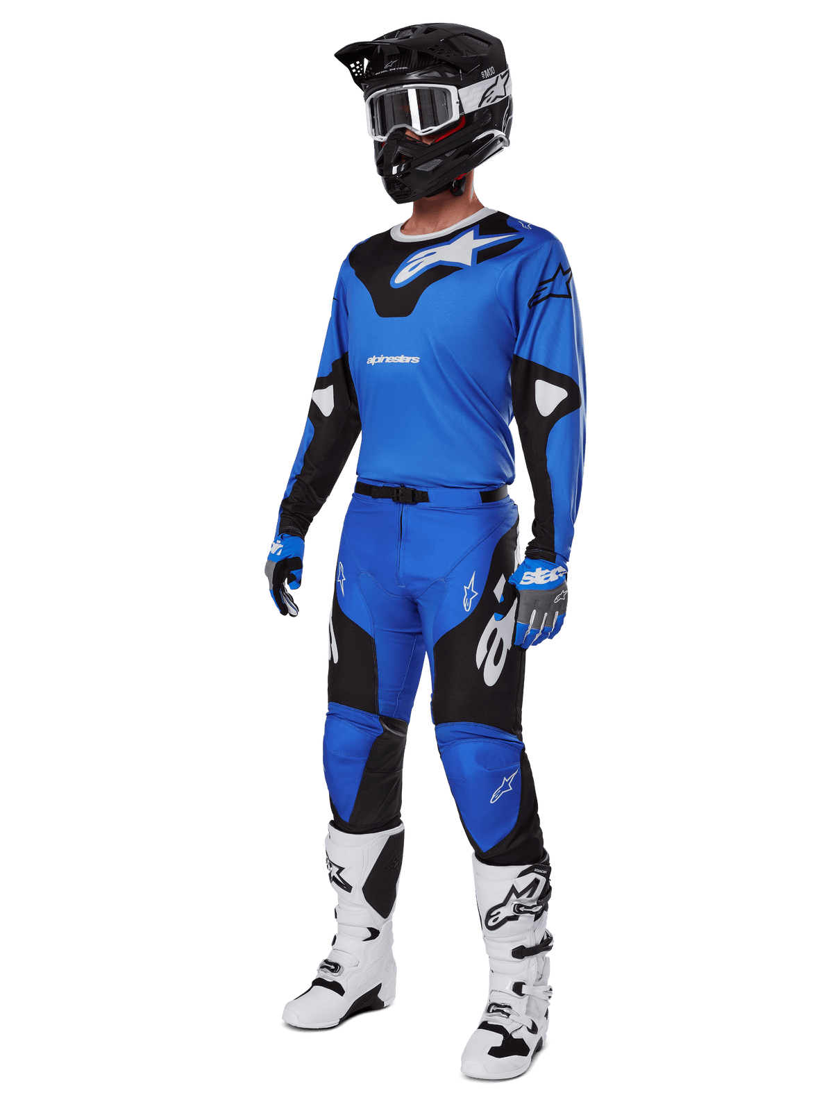 Motocross rider wearing complete racing gear, featuring Alpinestars 2025 Racer Veil Pants in Blue and Black, matching blue jersey with white accents, black helmet with white goggles, white and black boots, and blue gloves, coordinated outfit for off-road racing