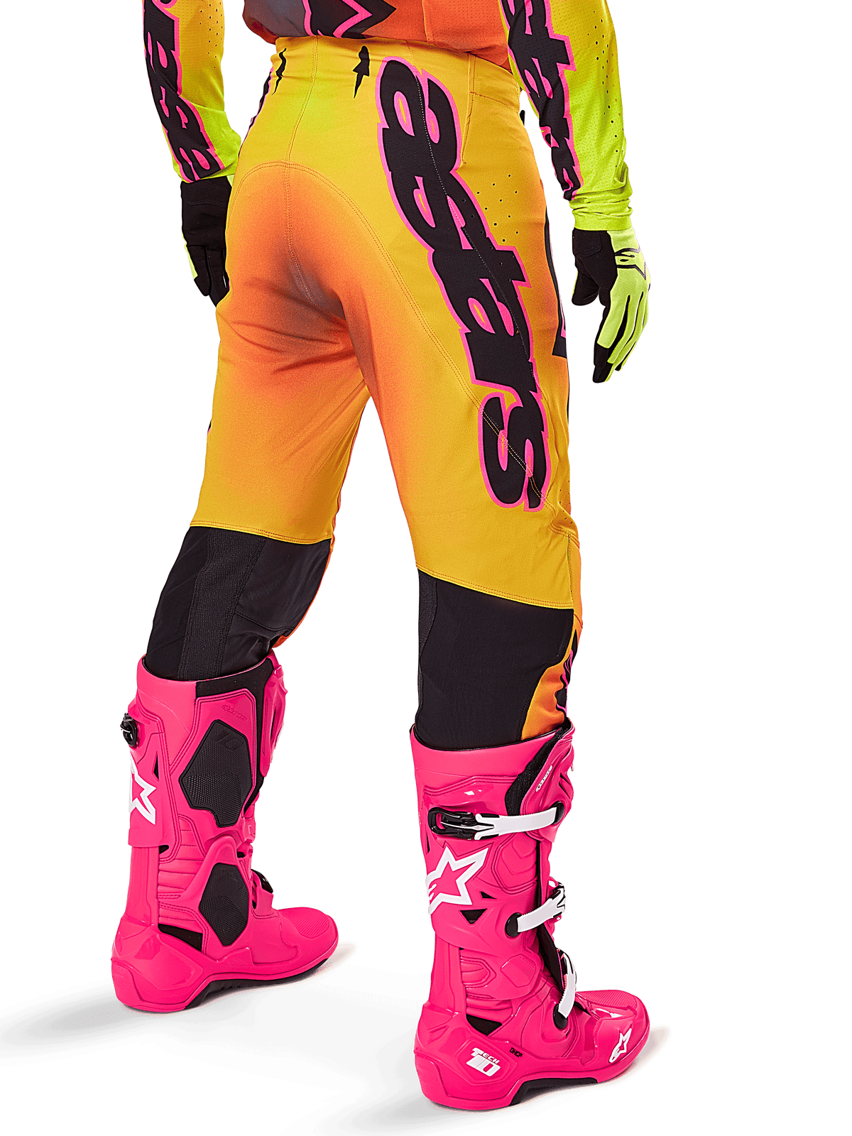 Alpinestars 2025 Supertech Lipan Gear Set, Rear view of yellow and orange gradient motocross pants with bold black branding, paired with bright pink Tech 10 boots and yellow gloves, professional off-road racing equipment