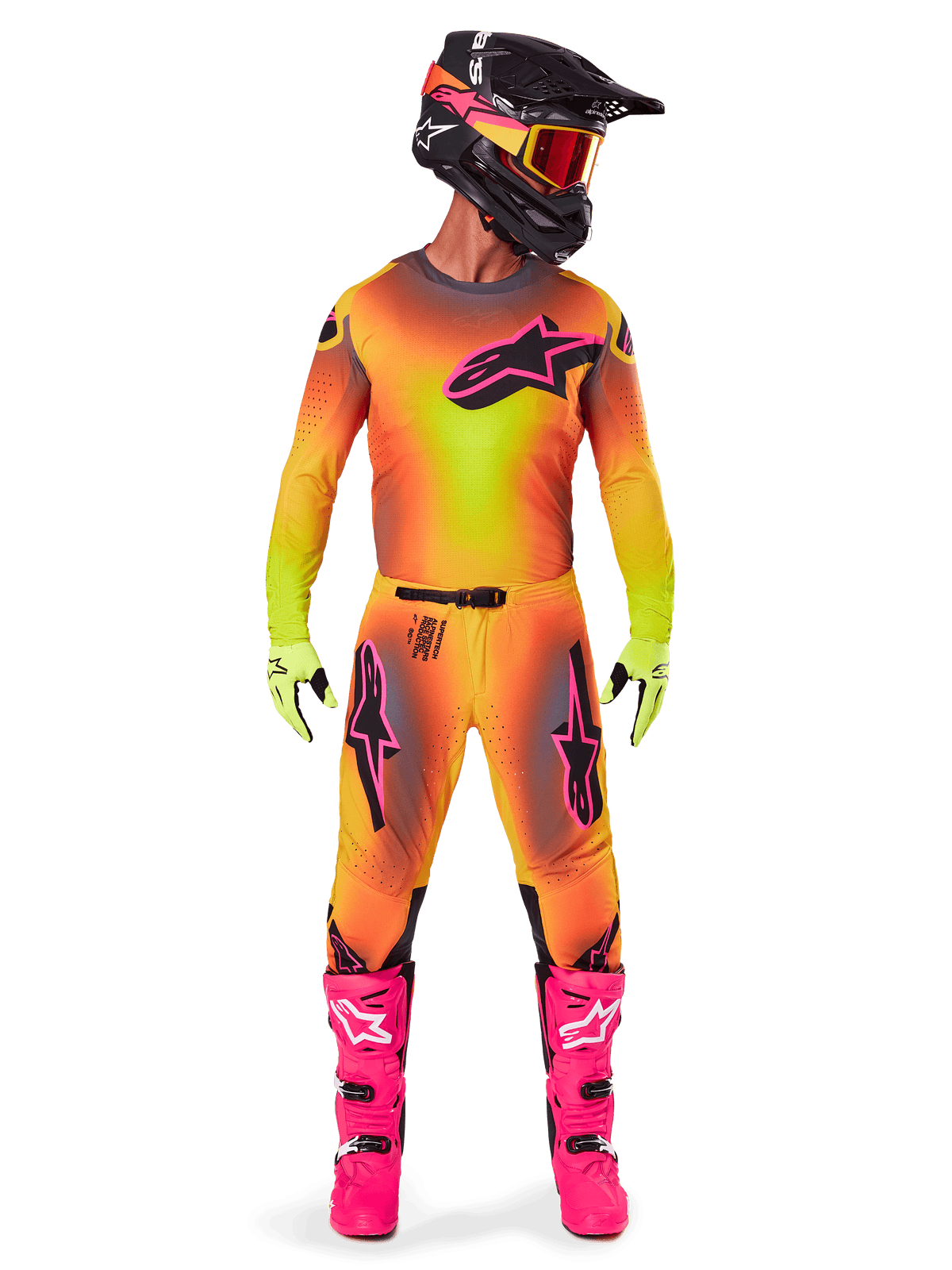 Alpinestars 2025 Supertech Lipan motorcross uitrusting, motocrossrijder met een opvallend geel en roze kleurverloop, bijpassende jersey met lange mouwen, felroze laarzen, limoengroene handschoenen en een zwarte helm met oranje bril