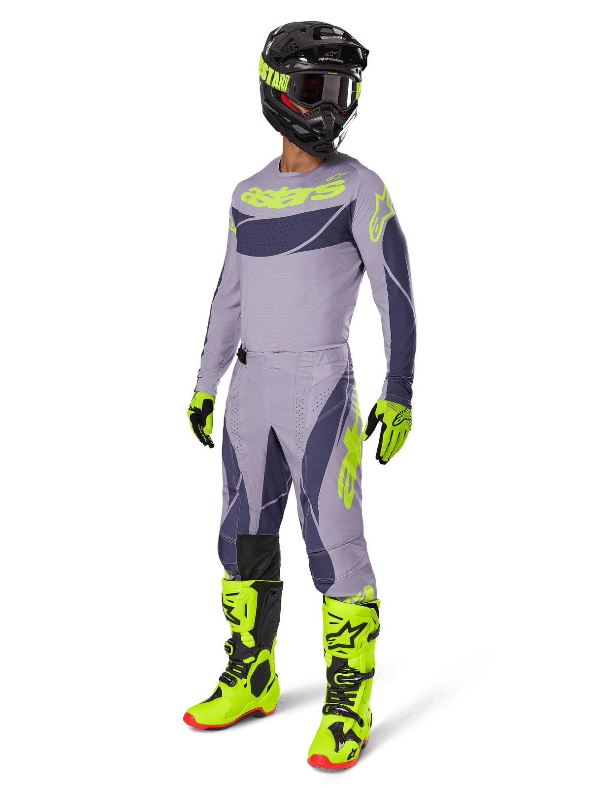 Alpinestars 2025 Techstar Dreem crossbroek, motorcrossbroek, grijs en donkergrijs met neongroene accenten, gedragen met bijpassende jersey, fel neongroene laarzen en zwarte helm, volledige professionele motorcrossuitrusting