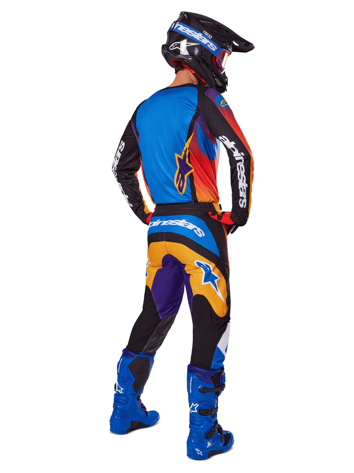 Motocross rider from the back wearing Alpinestars 2025 Fluid Wurx Pants, Multicolor design with blue, orange, yellow, and purple accents, paired with a matching jersey, bright blue boots, and black helmet, complete off-road racing gear.