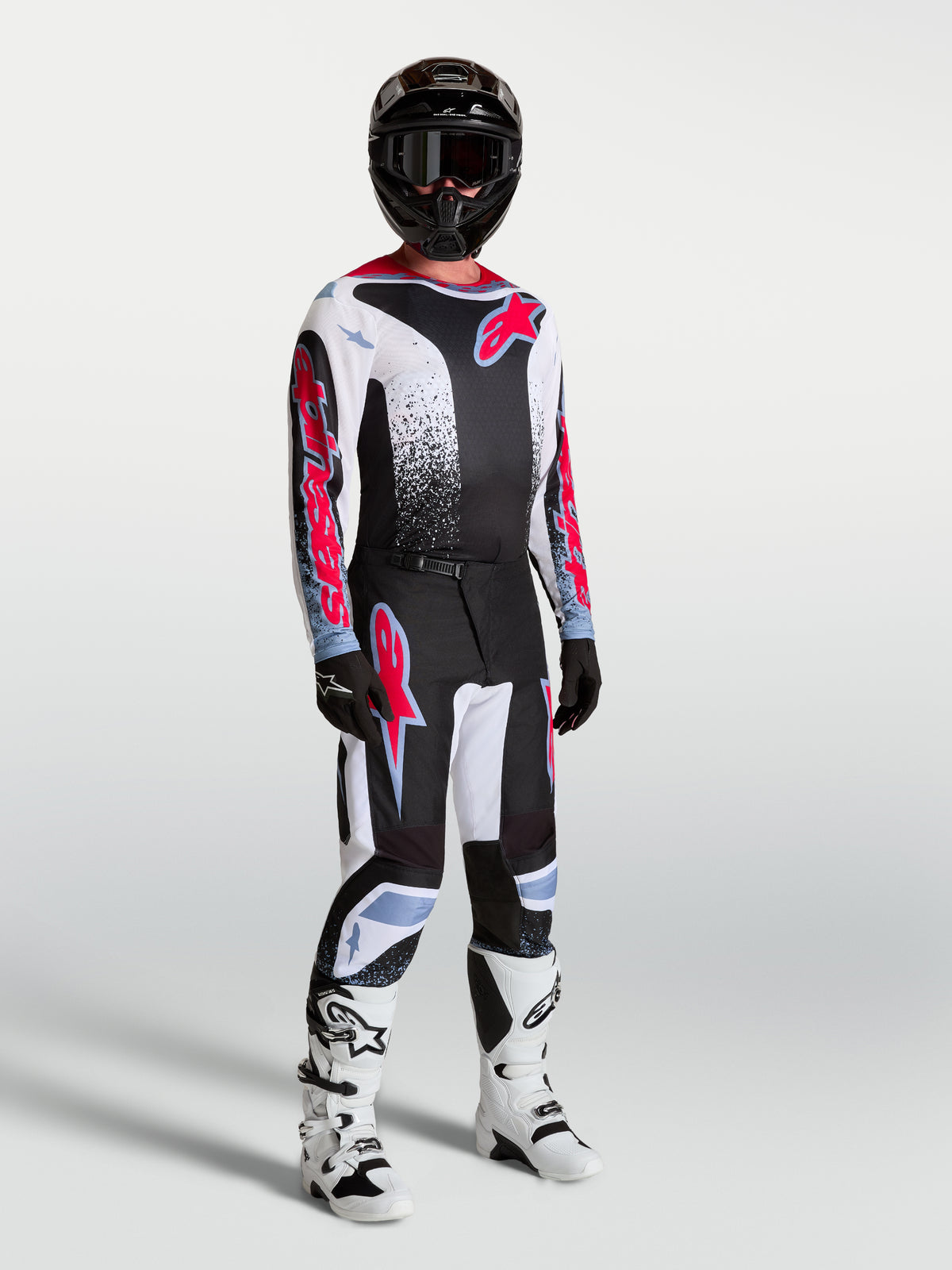 Alpinestars Fluid Drag broek, herenmotocross-uitrusting in zwart en wit met fluorode accenten.