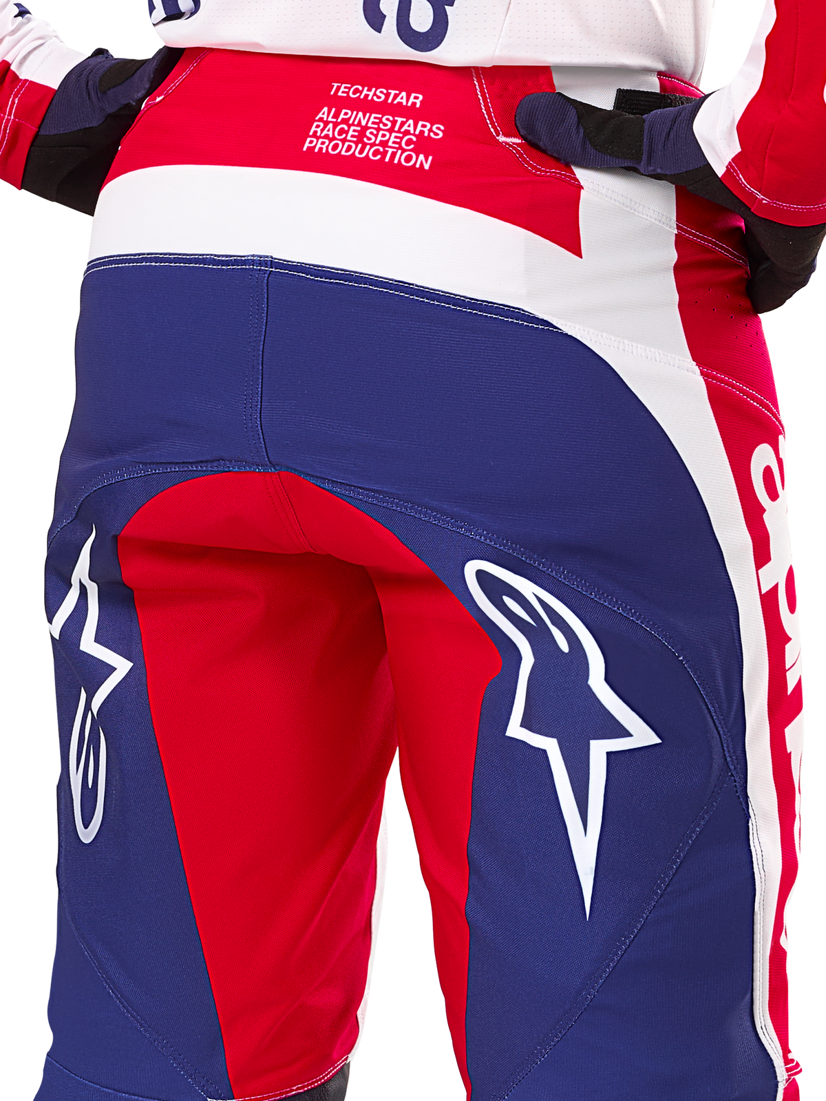 Alpinestars Limited Edition Techstar Fortitude Hose, Motocross-Hose, Rot, Weiß und Blau, Rückansicht mit großen weißen Stern-Logos auf dem Gesäß und Techstar Race Spec-Branding, strapazierfähige Performance-Textilien für Offroad-Rennsport