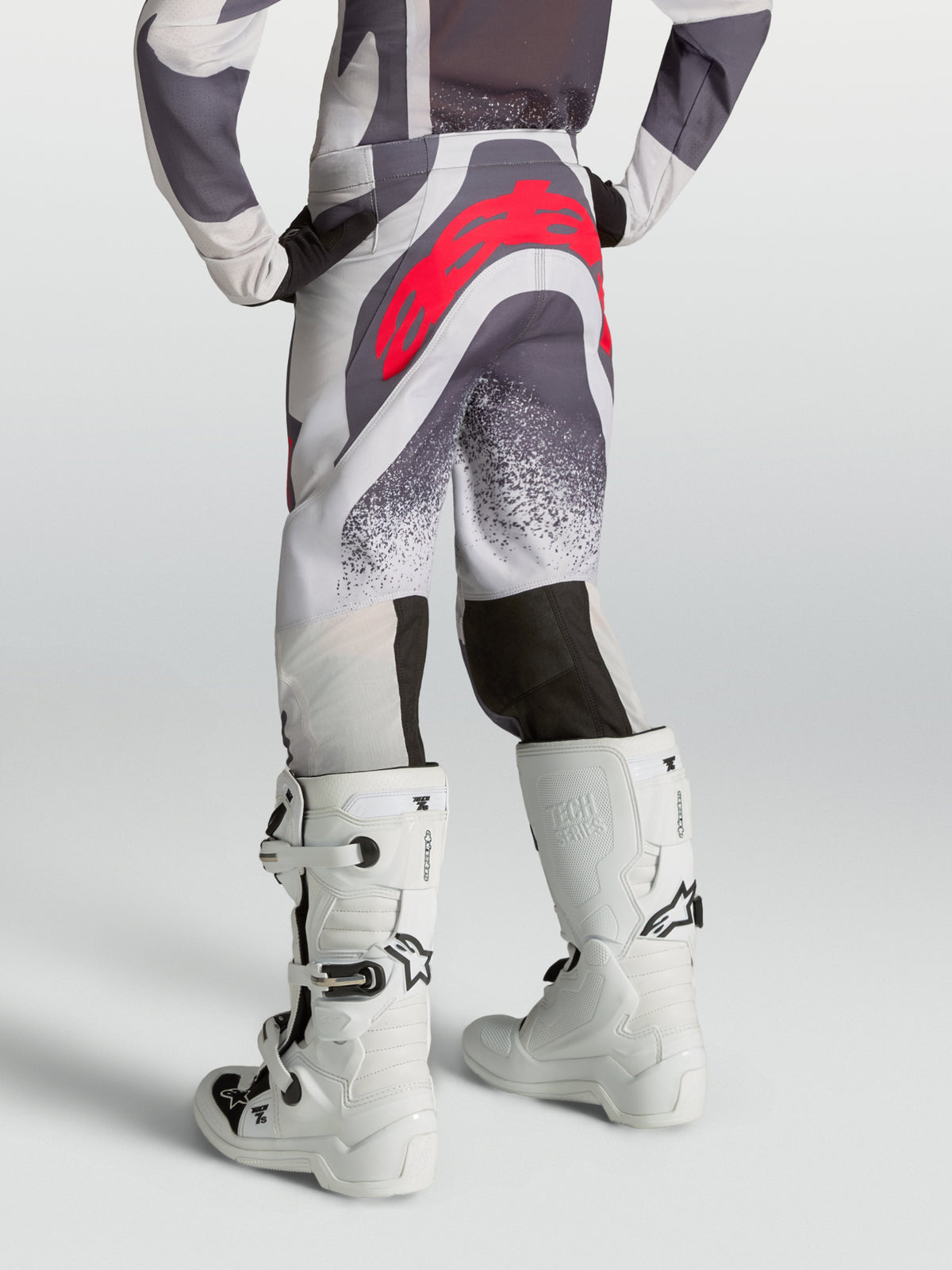 Alpinestars Supertech Swan Junior, pantalon de motocross gris et lilas avec logo rouge, vue de dos sur mannequin.