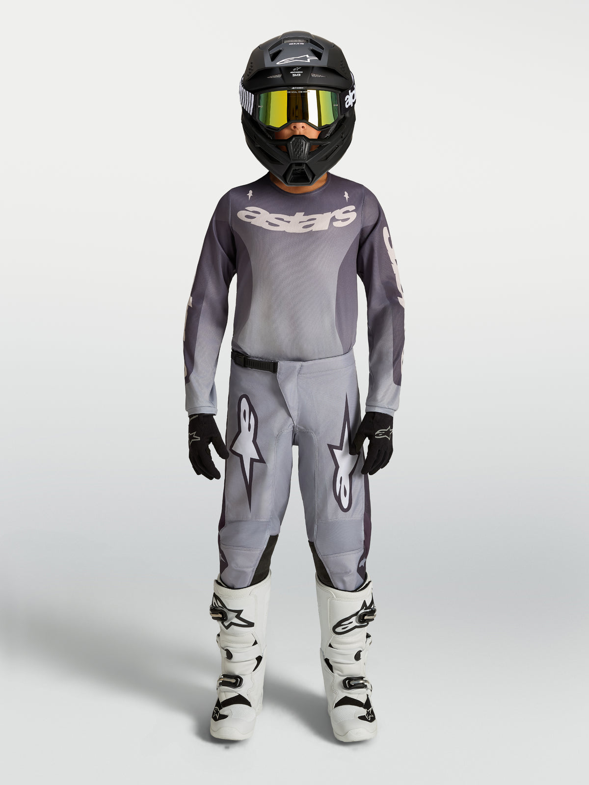 Alpinestars Fluid Amber Junior, pantalon de motocross pour enfant, gris et sable, construction en polyfibre 600D, porté avec un équipement complet