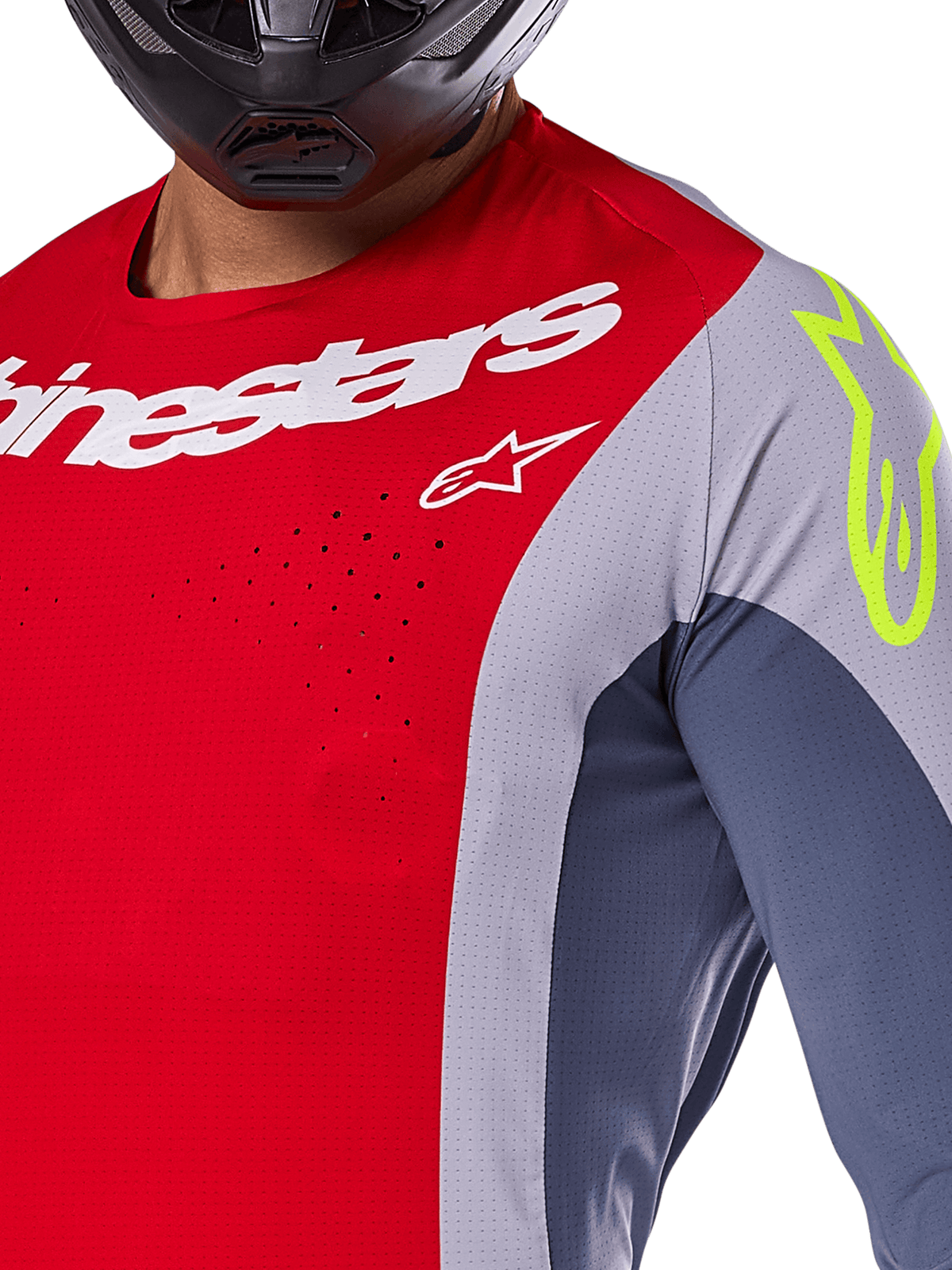 Alpinestars 2025 Techstar Melt Trikot, Motocross-Trikot, Hellrot und Grau mit dunkelblauen Einsätzen, mit weißem Alpinestars-Branding und einem neongelben Logo auf der Schulter, Nahaufnahme mit lasergeschnittenen Belüftungsperforationen und einem schwarzen Helm.