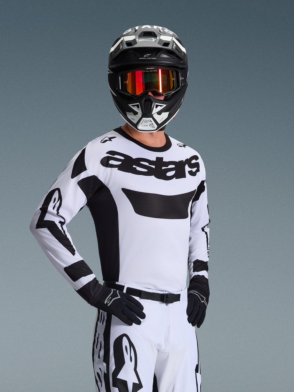 Alpinestars 2026 Racer Riway Jersey, Motocross Jersey, White and Black, featuring bold 'astars' logo on chest, worn with matching white pants and black gloves, black and white helmet with red reflective goggles, professional off-road racing gear