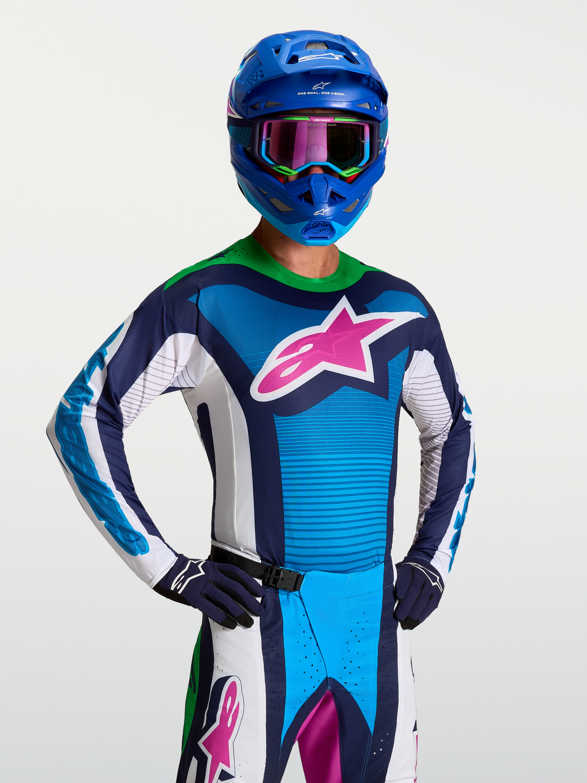 Alpinestars maillot Techstar Maven, maillot de motocross bleu et blanc pour homme avec logo rose et col vert fluo.