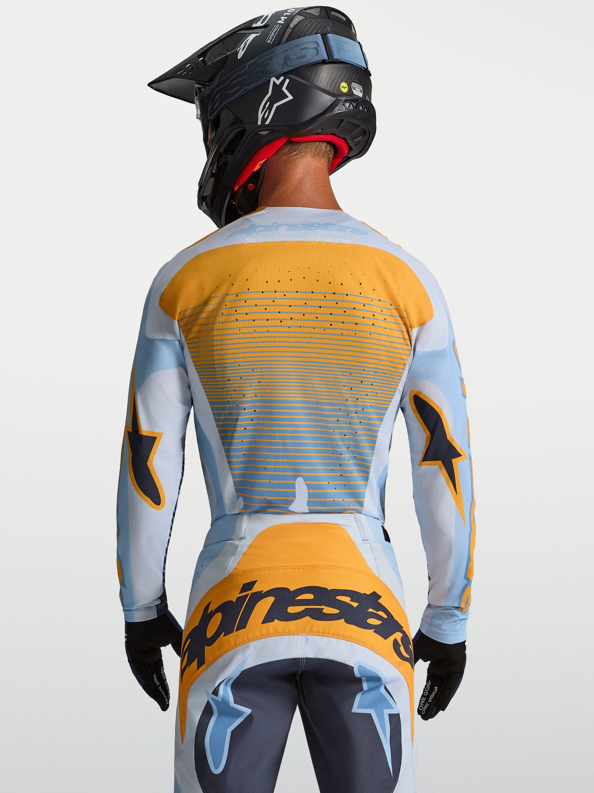Maillot Techstar Maven Alpinestars, maillot de motocross pour homme, bleu et orange, vue de dos avec perforations laser pour la ventilation.