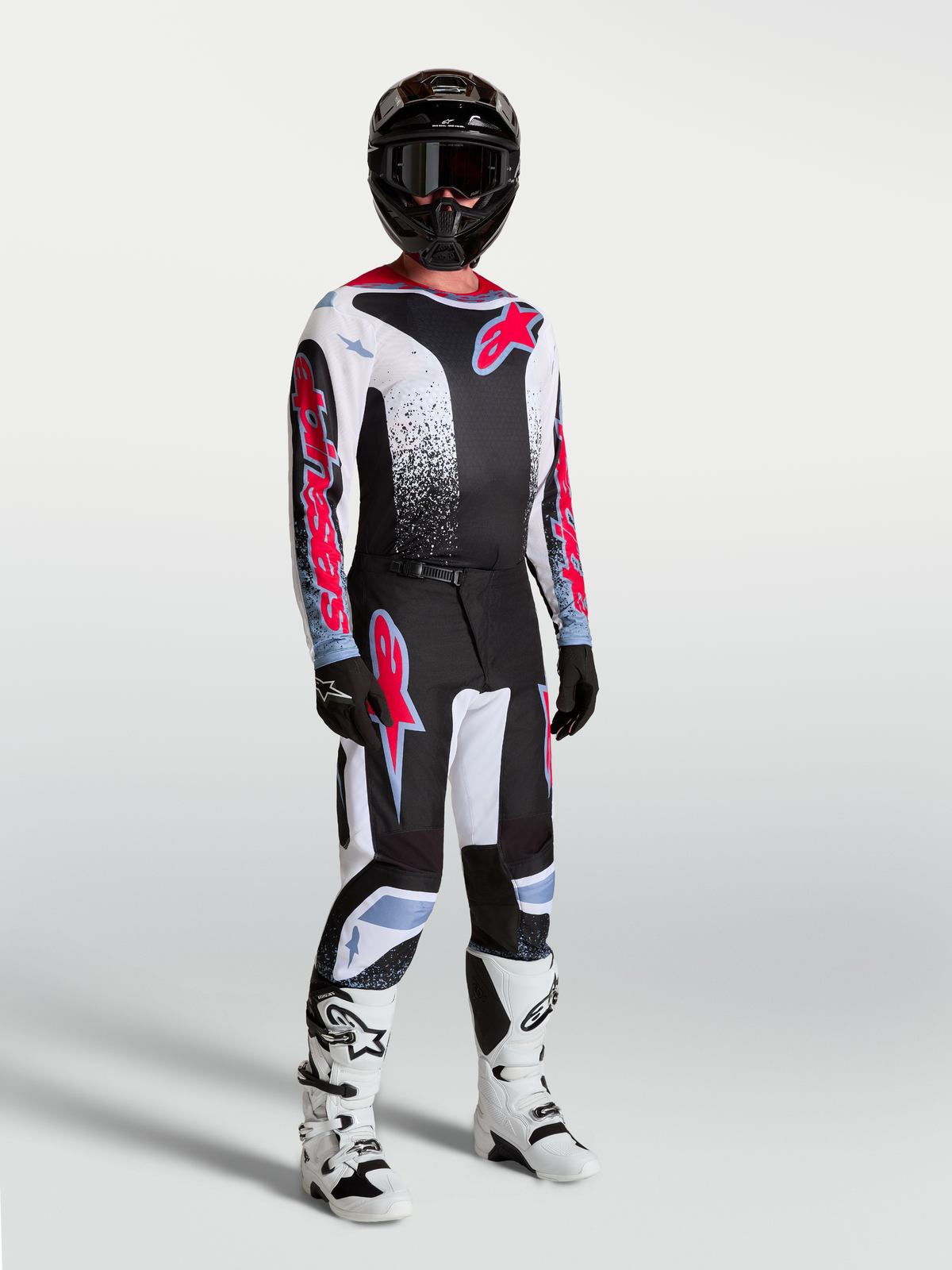 Alpinestars Fluid Drag Jersey, Men's Motocross Jersey, Black, White, and Red Fluo, breathable textile on model with full gear.
