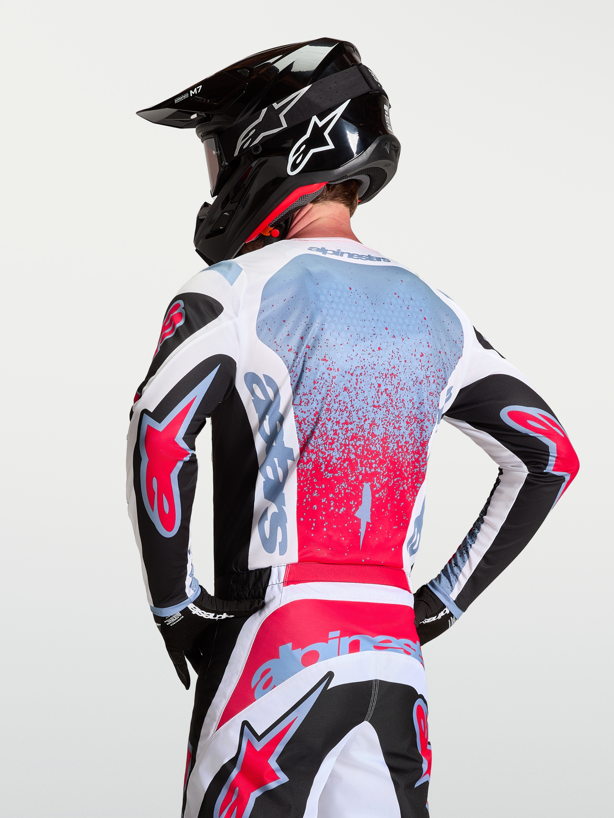 Alpinestars Fluid Drag Jersey, motocross gear for men in black, white, and red with light blue accents, featuring breathable polyfabric.