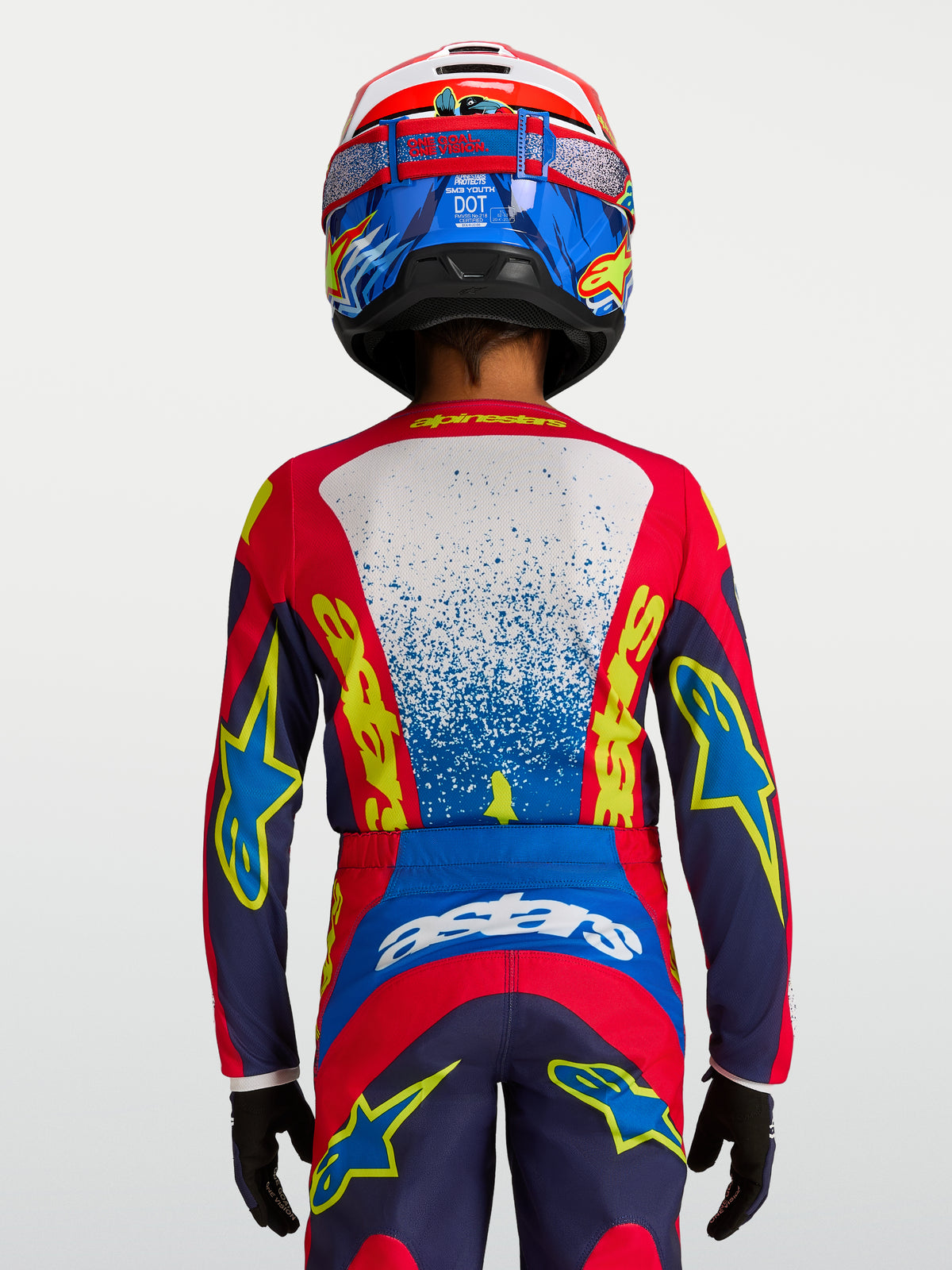 Maillot Fluid Drag Junior Alpinestars, haut de motocross pour enfant, bleu et rouge, coupe ergonomique, vue de dos.