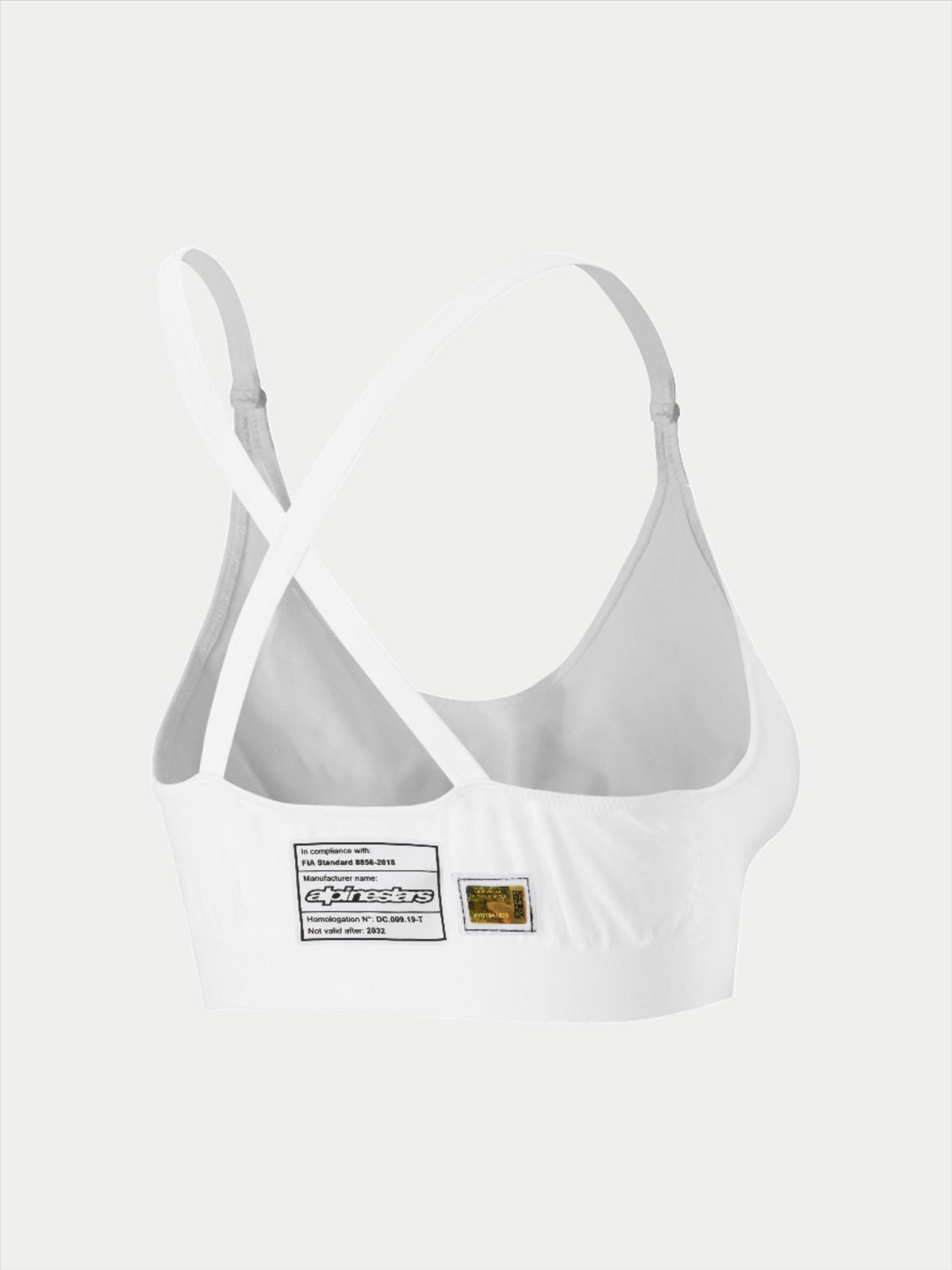Brassière Alpinestars Stella TECH ZX, sous-vêtement de course blanc résistant aux flammes, vue arrière montrant la conception des bretelles croisées, avec étiquette d'homologation FIA 8856-2018 et hologramme, couche de base légère et performante pour femmes