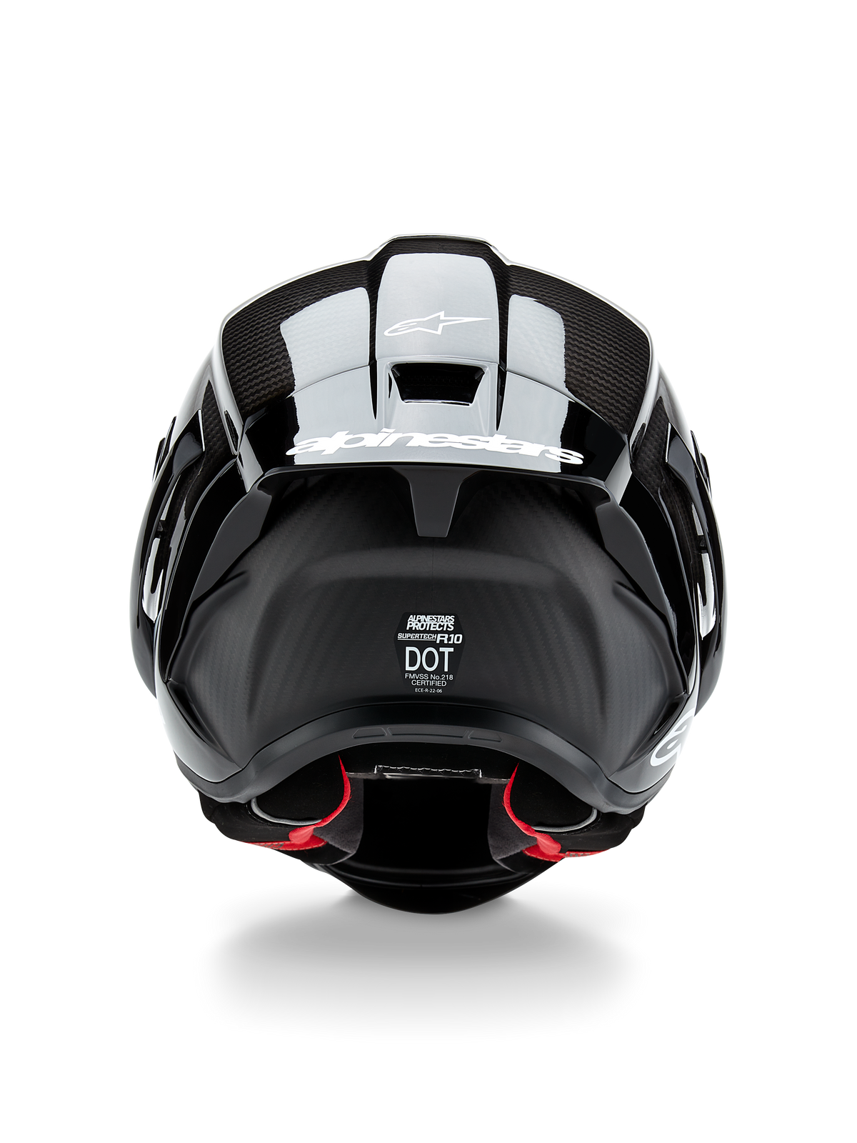 Alpinestars Supertech R10 Solid helm, motorhelm, zwart carbon mat en glanzend, achteraanzicht met carbonvezeltextuur, aerodynamische spoiler met wit Alpinestars-logo, DOT- en ECE-veiligheidscertificeringslabels en rode binnenvoering