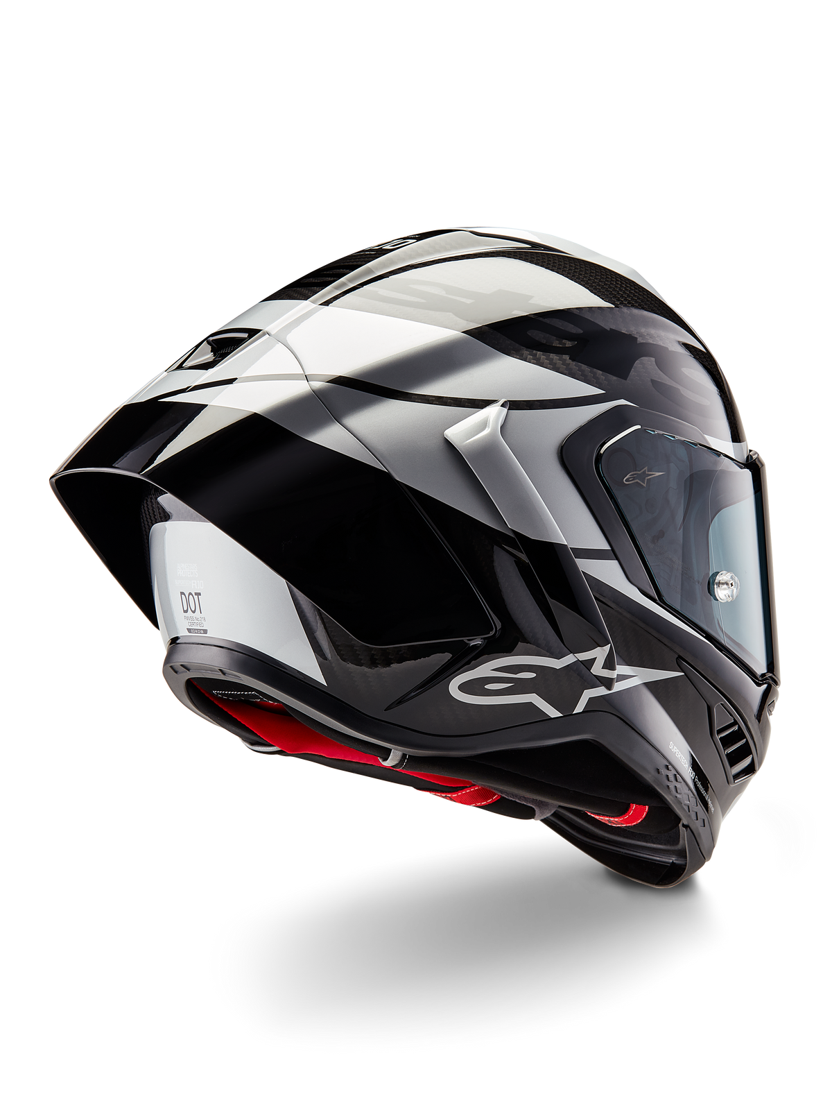 Alpinestars Supertech R10 Element helm, Black Carbon Silver Black Glossy, driekwart achteraanzicht met aerodynamisch raceprofiel, glanzende carbon schaal met geometrische grijze en zwarte graphics, Alpinestars-logo en rode binnenvoering