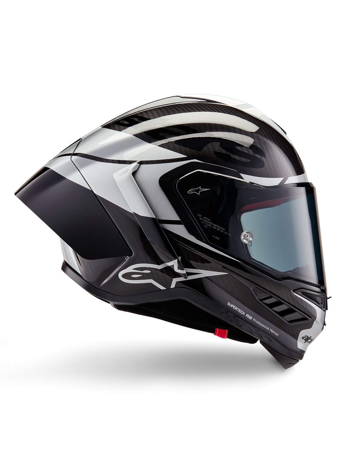 Alpinestars Supertech R10 Element helm, integrale motorracehelm, zwart carbon, zilveren en zwart glanzende afwerking, zijaanzicht met aerodynamische koolstofvezel schaal, helder vizier en opvallende Alpinestars-branding