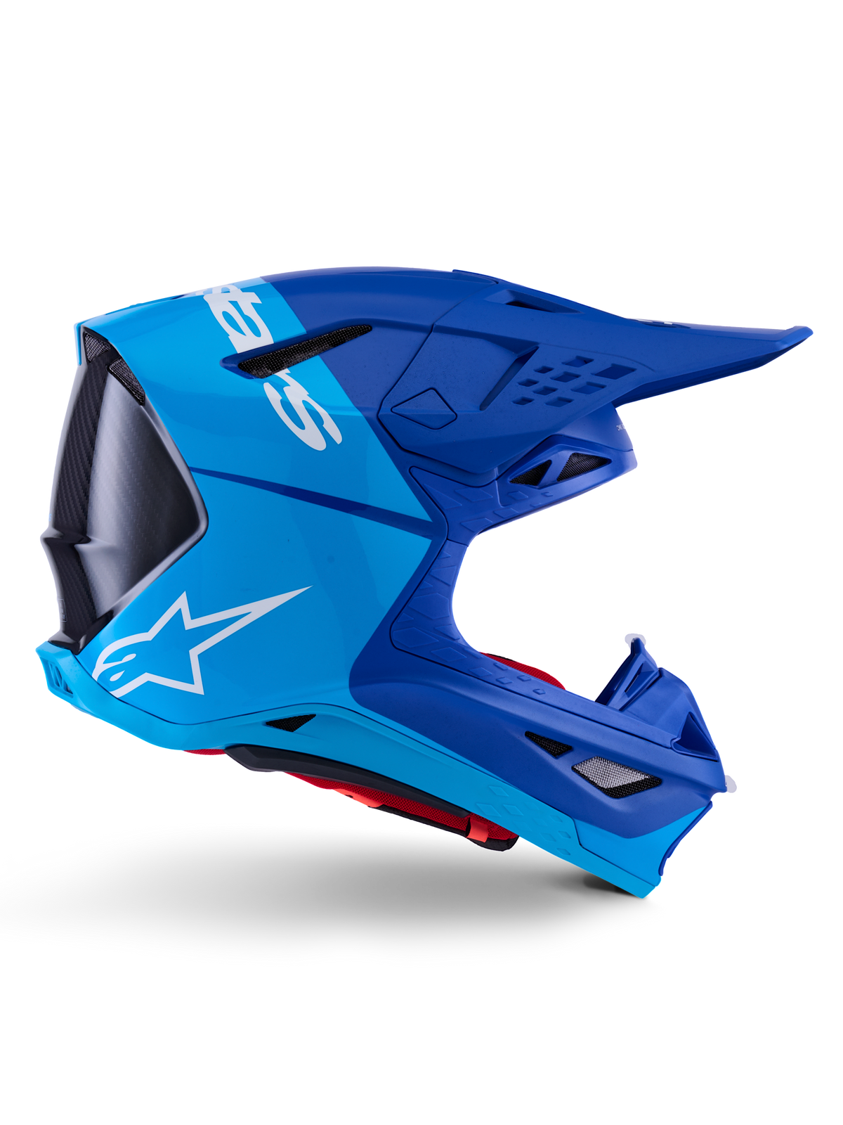 Casque Alpinestars Supertech M10 Flood, casque de motocross, bleu métallique et bleu moyen avec accents en carbone noir, vue de profil, logo blanc, design aérodynamique avec ports de ventilation, détails de texture en fibre de carbone, protection professionnelle pour la course tout-terrain