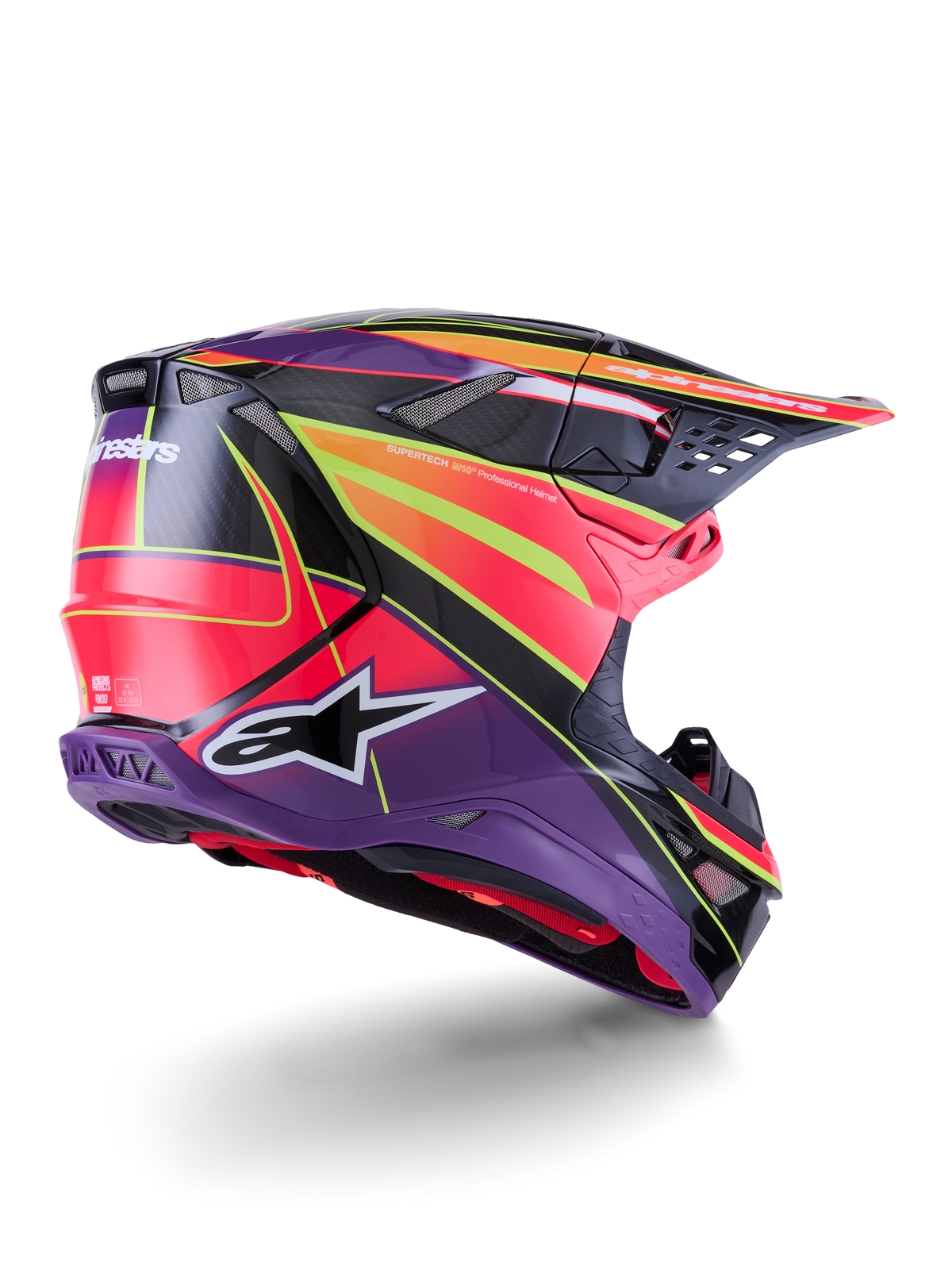 Casque Alpinestars Supertech M10 Era, casque de motocross, rose, violet et jaune fluo brillant, vue de trois-quarts arrière montrant la coque aérodynamique en fibre de carbone, les ports de ventilation intégrés et les graphismes audacieux de la marque, équipement de course tout-terrain haute performance